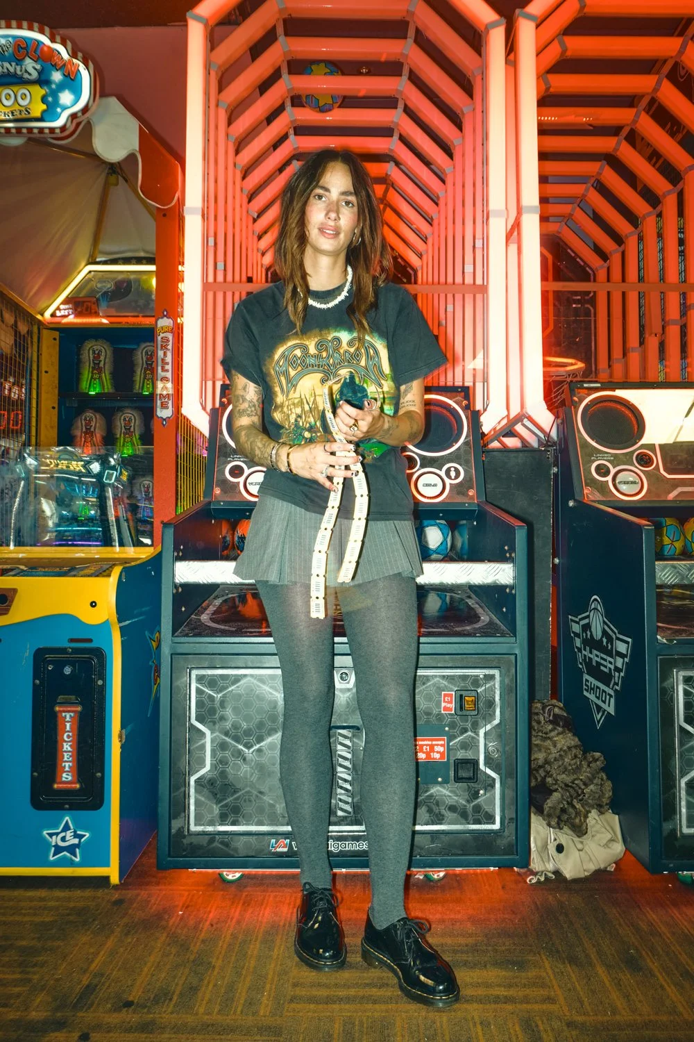 Creative Dr. Martens campaign photography inside a neon-lit arcade, combining movement, front flash and authentic youth culture storytelling for a commercial fashion campaign.