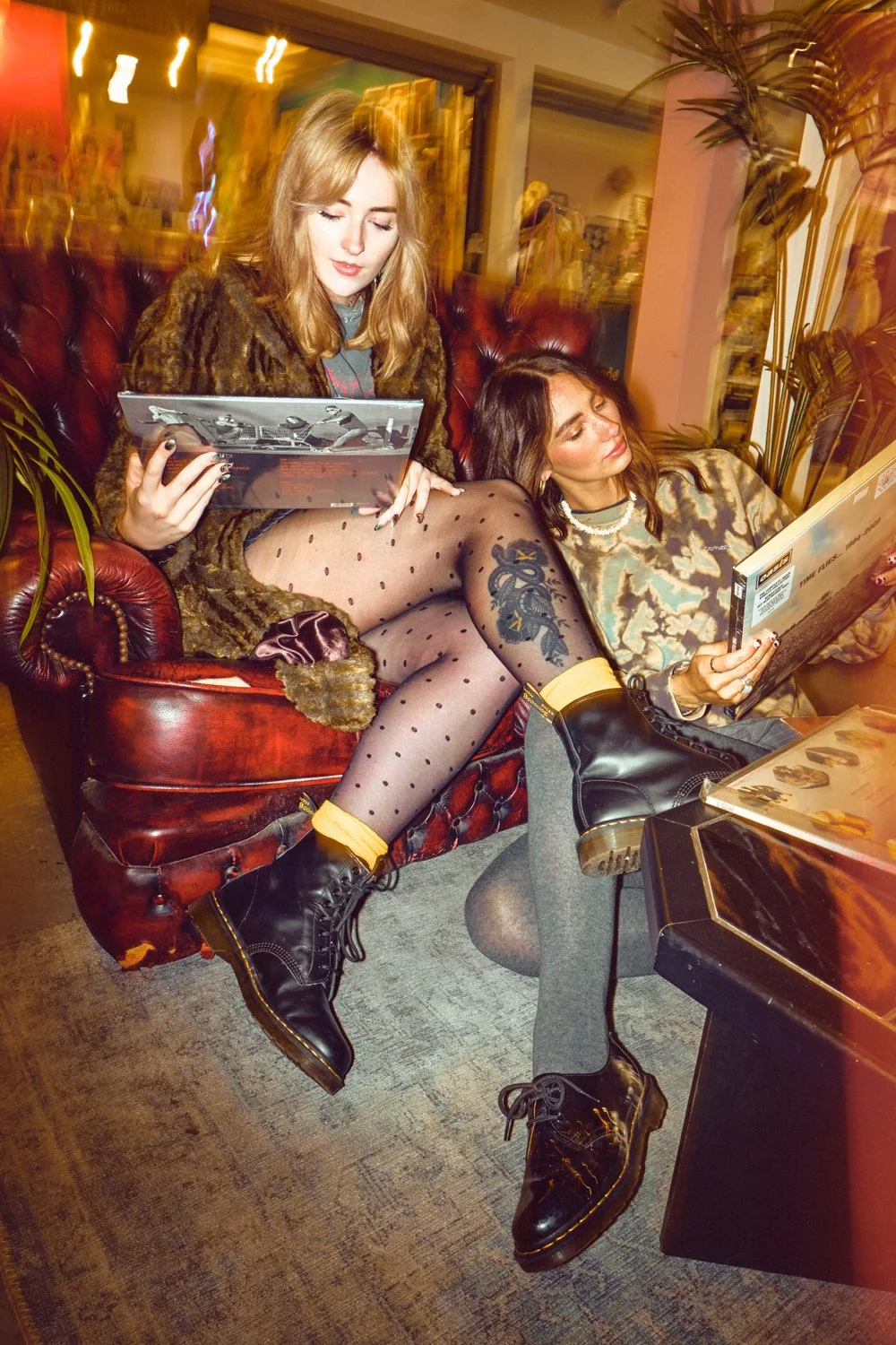 Dr. Martens youth culture campaign photography featuring two models with vinyl records in an independent record shop.