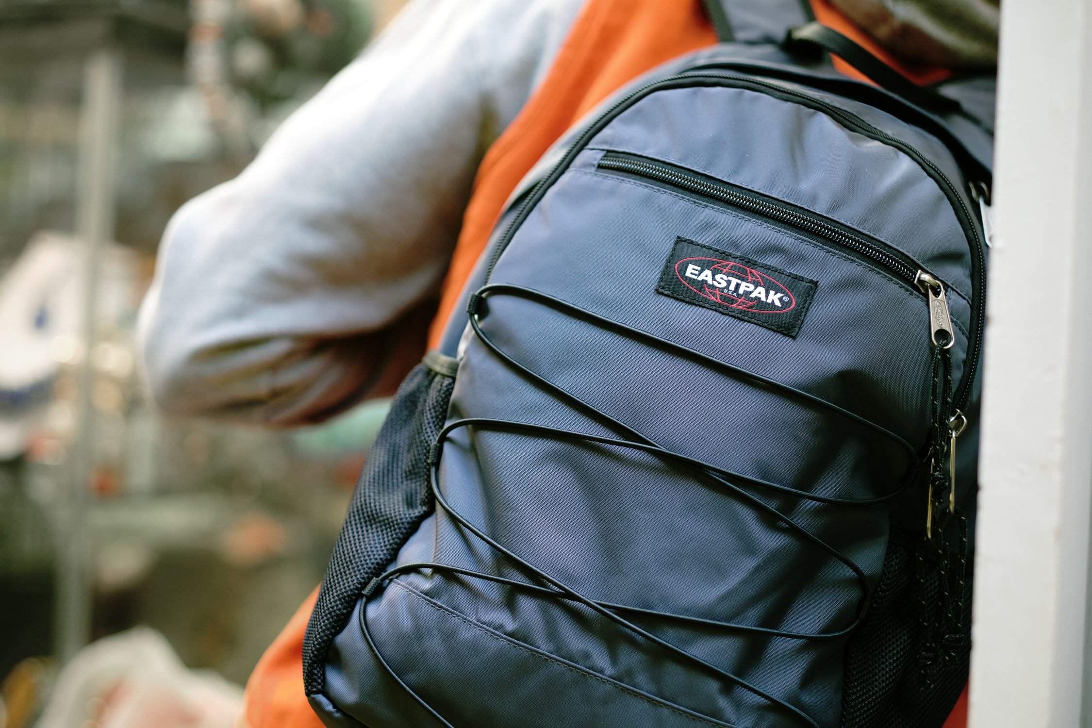 Model carrying an Eastpak Quidel Powr backpack on location in London during a streetwear campaign shoot.