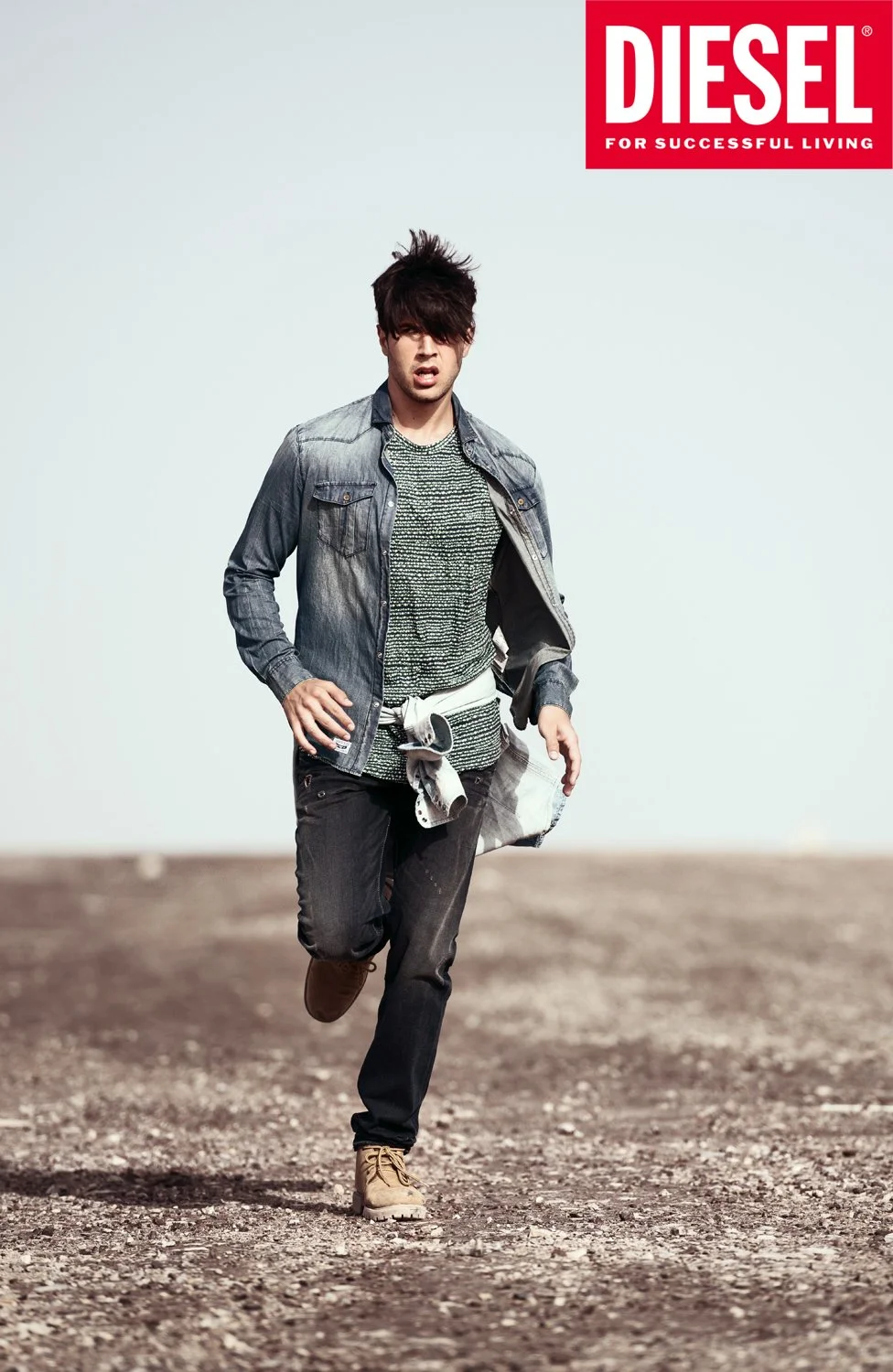 Model photographed in motion in the Dubai desert for a Diesel commercial fashion campaign.