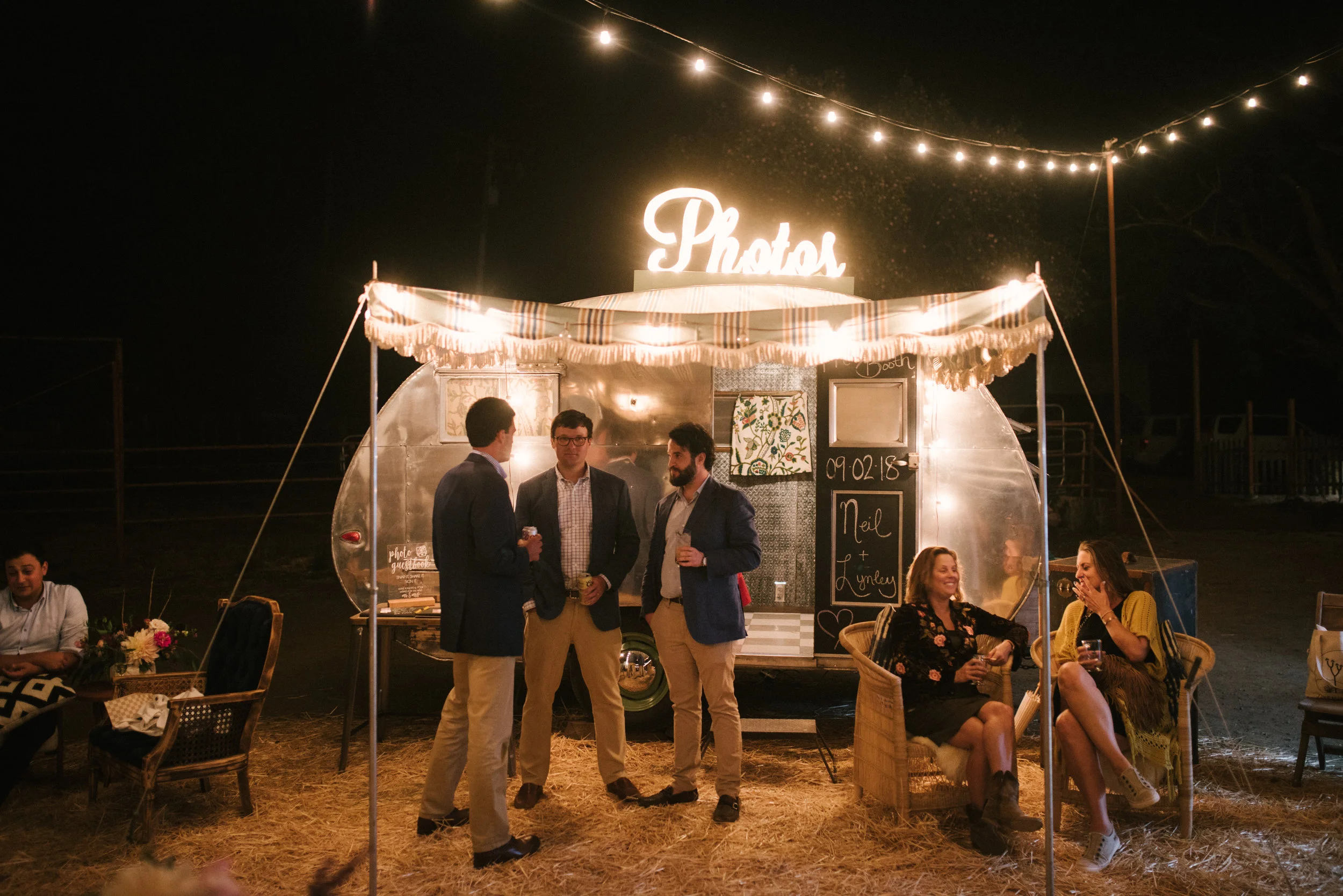 A perfect evening shot of Tinker Tin Trailer Co.’s vintage photo booth trailer and their light up photo sign. The most fun and unique photo booth option in California and the Western United States