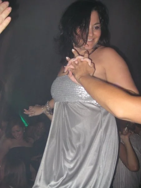 Dancing on a table in some gaudy, flashy outfit. Yea, that's about right.
