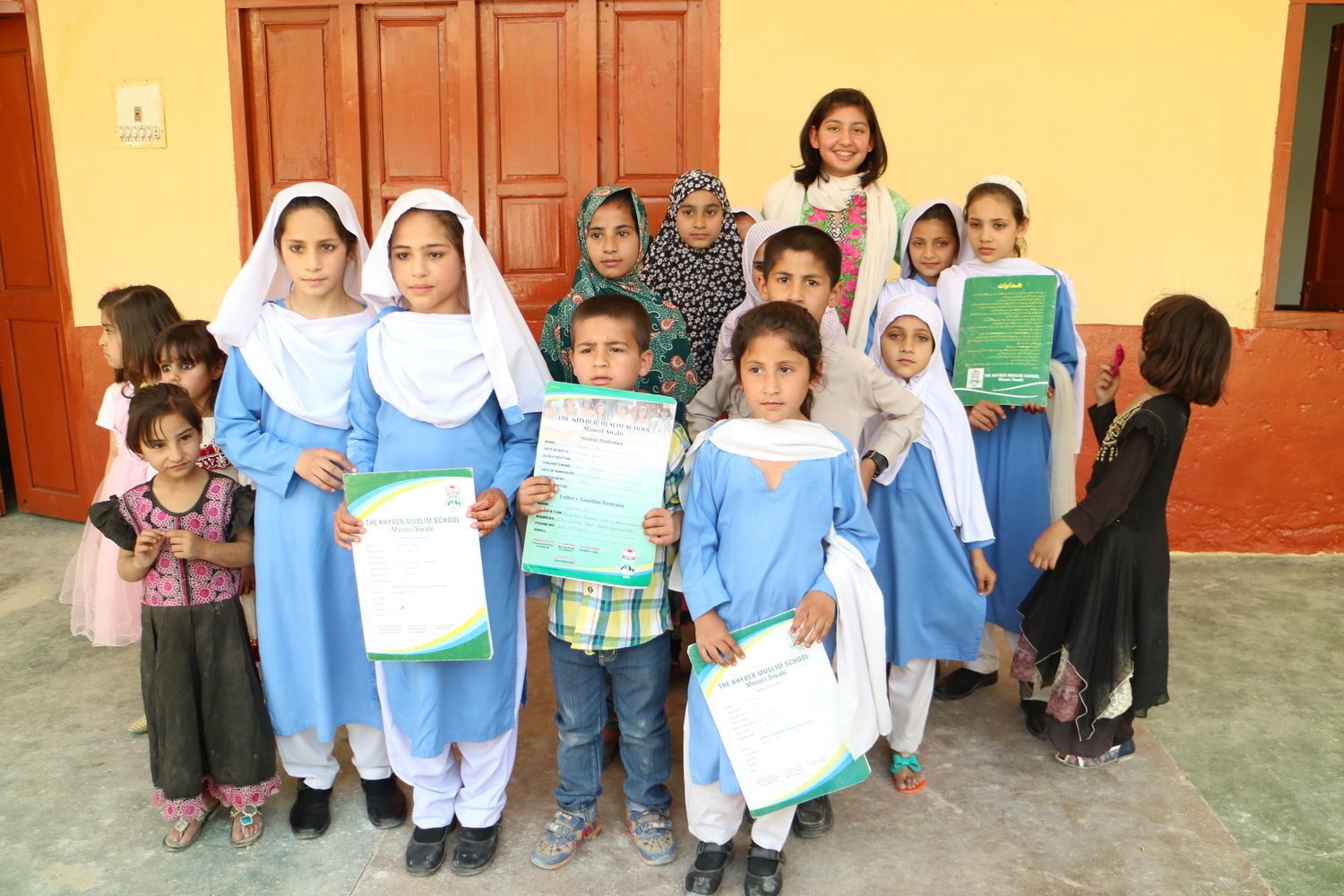  Zoha with students after the opening ceremony. The documents they are holding are their exam results—all students passed! 