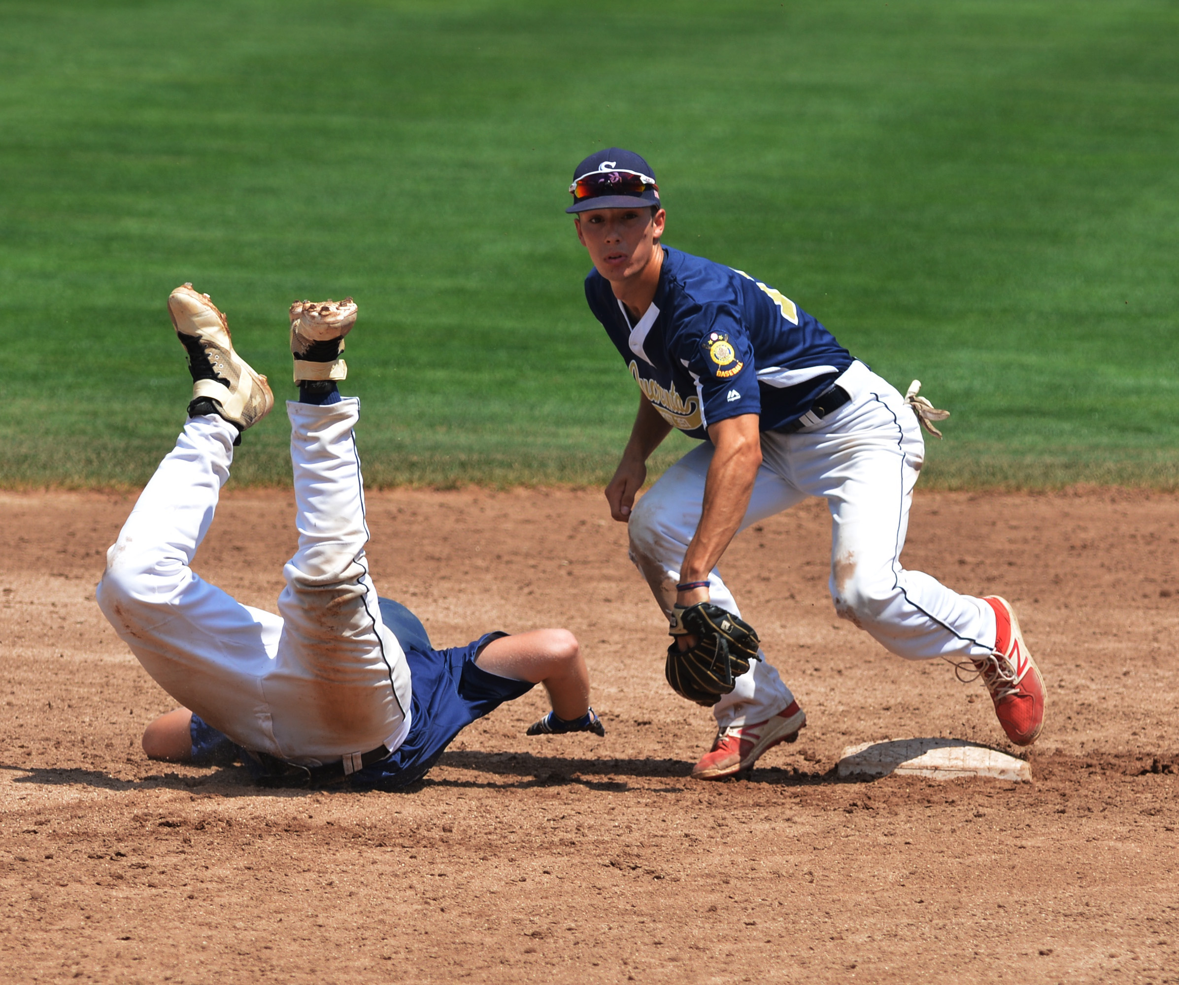 David Turco catches the ball at second base while Joe Celio tries to slide during Shrewsbury Post 397's game against West Hartford at Hanover Insurance Park August 3, 2017. 