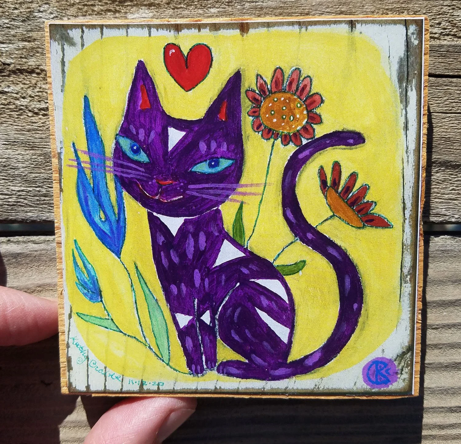 Bliss print on wood in hand 4 x 4.jpg