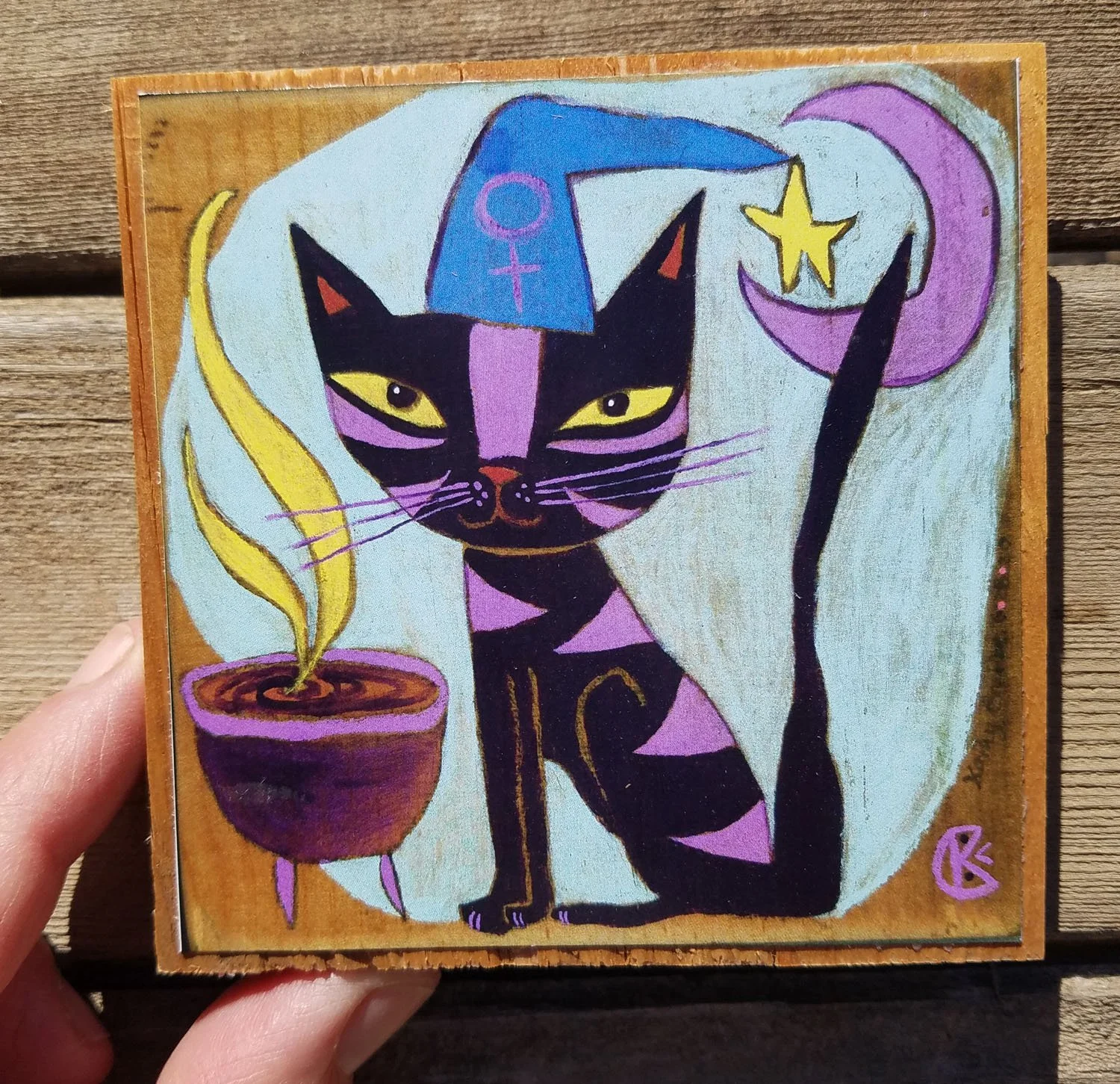 Pluto) print on wood in hand 3.75 x 3.75.jpg