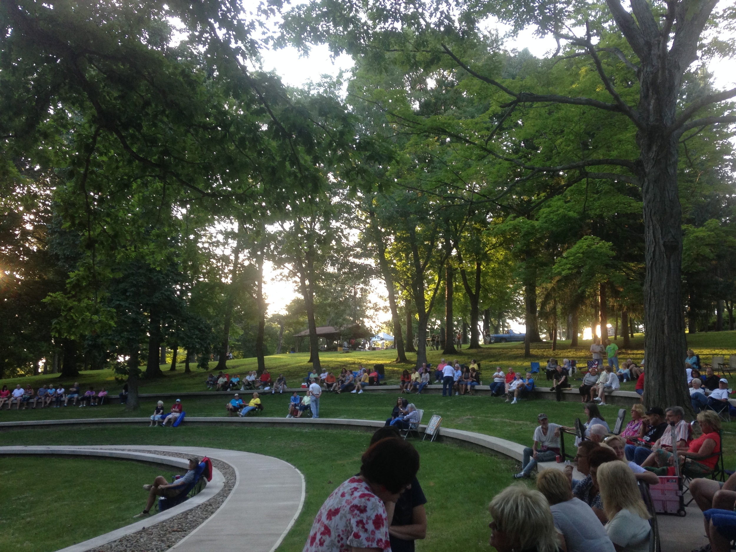 A crowd enjoys a summer performance at the amphitheater