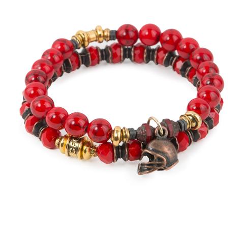 Red Zone (Set of Two) Red crystal glass and synthetic turquoise bracelet set of two with Czech glass accents, mixed metal detail, and copper-tone helmet charm. Measures approximately 7.5" in length. With the purchase of this bracelet set, 25% of gross profit goes to V-Day. All bracelet sets come with a hang-tag detailing the mission of each charity.
