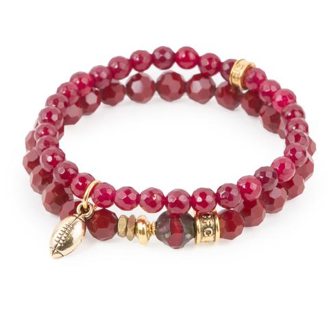 1st Down (Set of Two) Red-dyed jade and crystal glass bracelet set of two with Czech glass accent and gold mini football charm. Measures approximately 7.5" in length. With the purchase of this bracelet set, 25% of gross profit goes to V-Day. Each bracelet comes with a hang-tag detailing the mission of each charity.