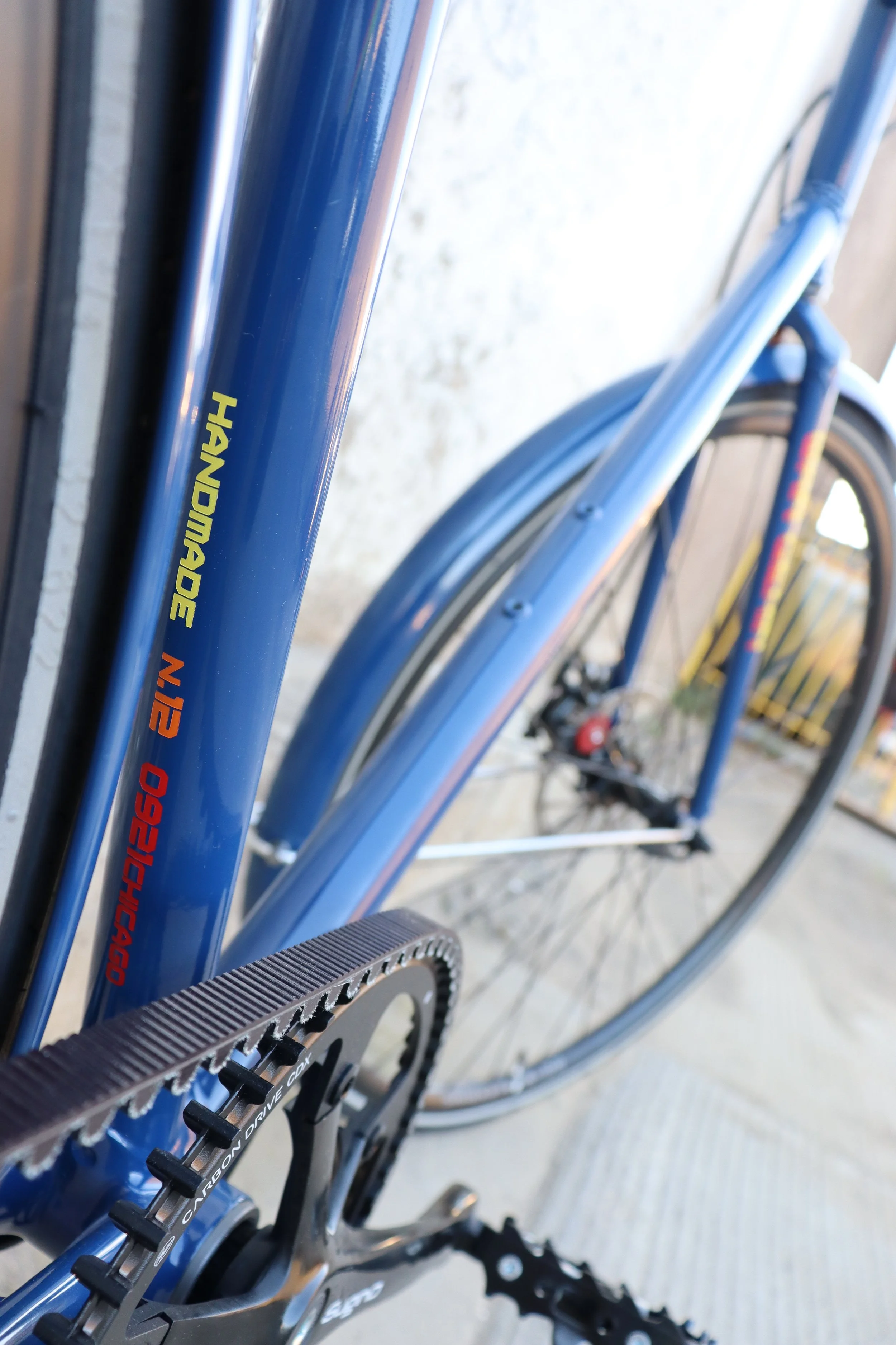  Lugged construction with custom-designed and 3D-printed stainless steel lugs   Steel tubing, Columbus ZONA   Satin navy powder coat finish with mixed-color branding   Shimano Alfine 8 hub with gates carbon belt drive, 700c wheels, Avid disc brakes  