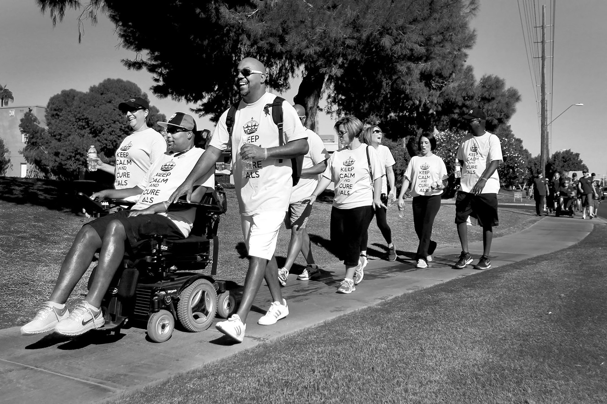 Mike drives alongside his former housemate Decarus Bennett, Rene and other supporters during the annual Walk to Defeat ALS in Scottsdale, Arizona.