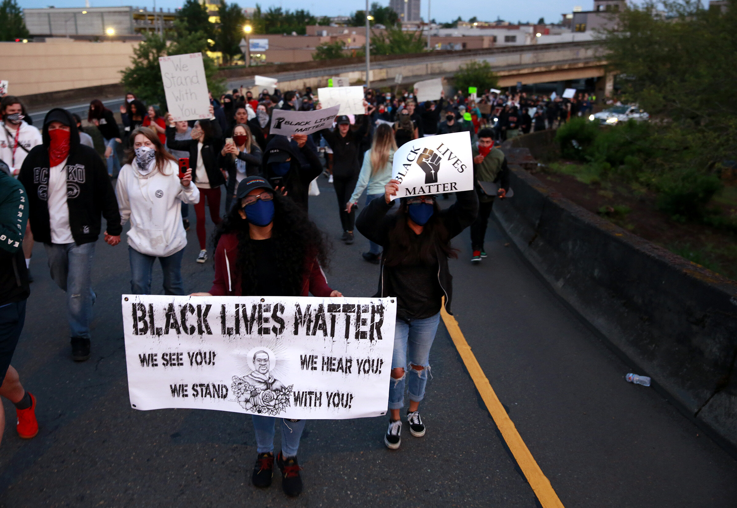  Protesters march up a ramp onto the Marion Street Bridge in Salem, Oregon, on Sunday, May 31, 2020. 