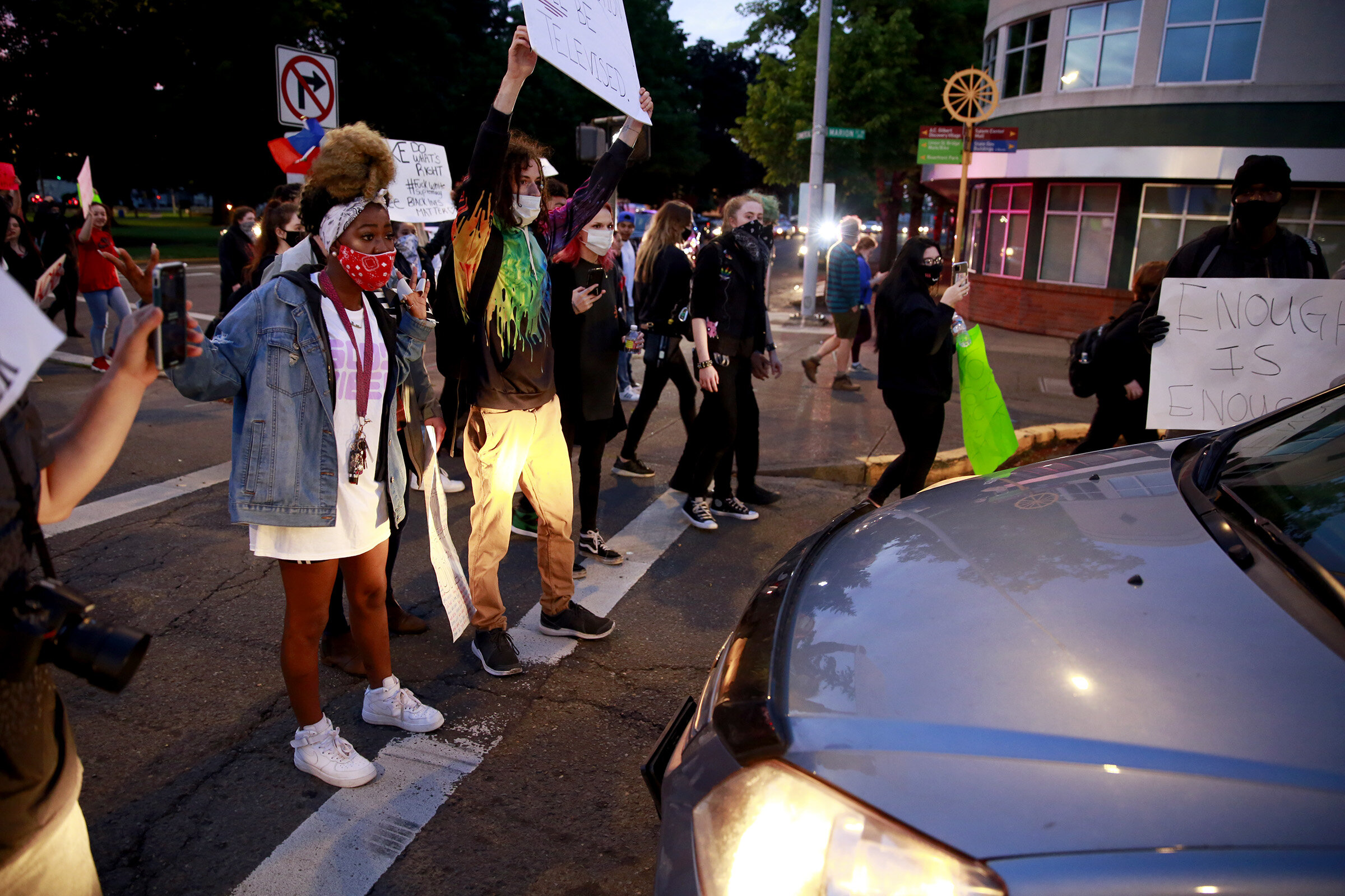  Protesters get into a confrontation with the driver and passenger of a vehicle during their march off the Marion Street Bridge into downtown Salem, Oregon, on Sunday, May 31, 2020. 