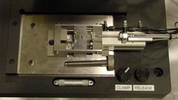 Figure 3 - Pneumatic Clamp, as well as the Hand Tightening Knob for the Izod Fixture. The Pneumatic Clamp can be Removed and the Hand Tightening Knob can be Inserted to Manually Control Clamping Force.