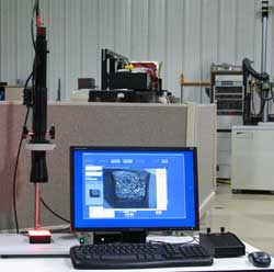 Figure 12 - Telecentric Lens with Stepper Motor and Computer Control for Automatic Measurement of Key Charpy Test Specimen Data Such as Notch Radius, Angle, and Depth.