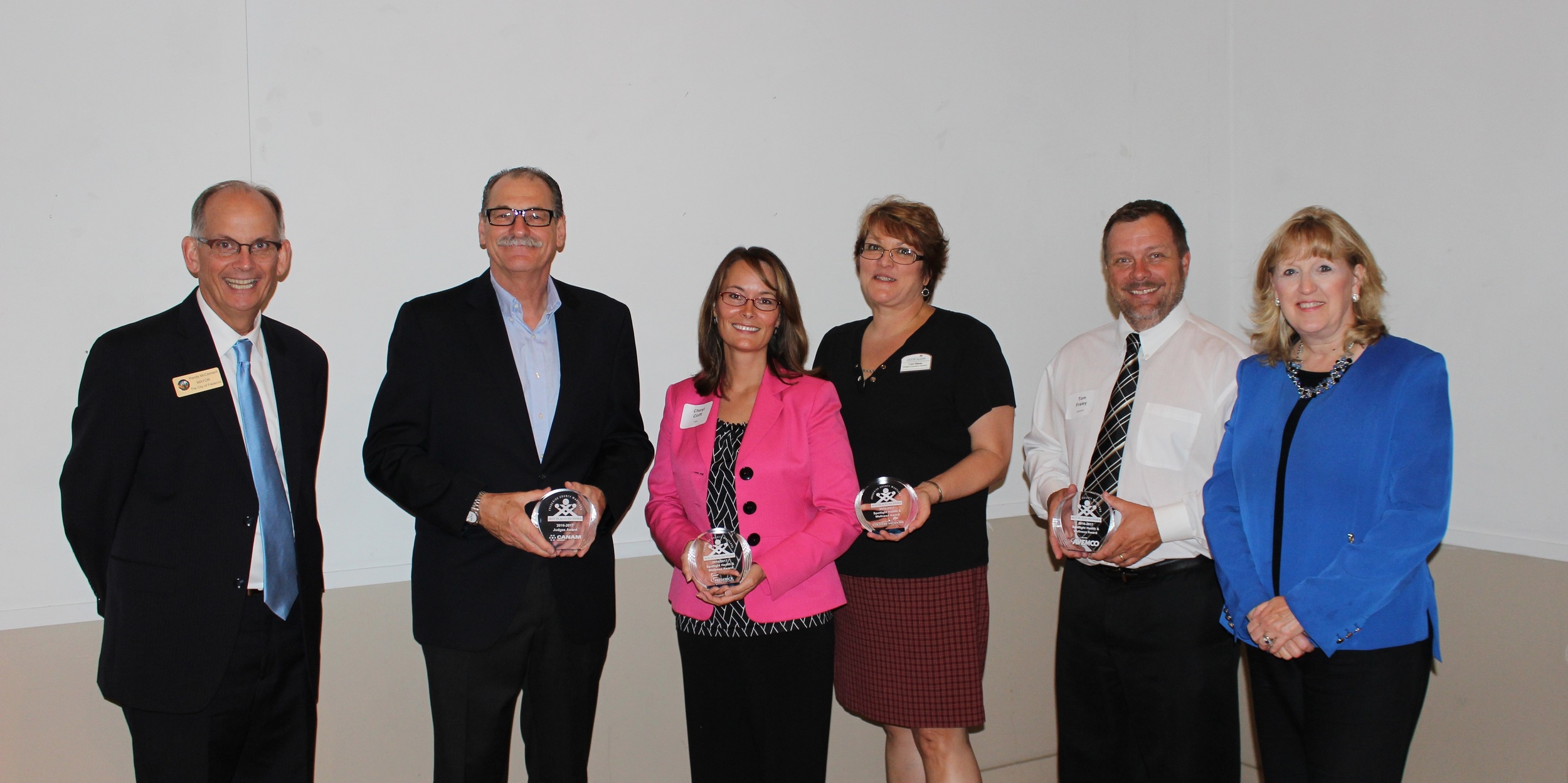 2016 Health and Wellness and Judges Choice Photo (from left to right): City of Frederick Mayor Randy McClement; Judges Choice Winner Michel Cyr, Canam Steel Corp; Spotlight Health & Wellness Winner Cheryl Cioffi, Sr. Vice President Patient Care Services, Frederick Memorial Hospital; Spotlight Health & Wellness Winner Carol Ditman, Executive Director, Country Meadows Retirement Communities; Spotlight Health & Wellness Winner Tom Fraley, Vice President of Support Operations, Avemco Insurance; Frederick County Executive Jan H. Gardner