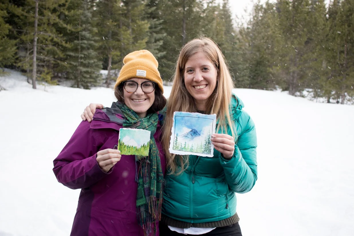 Nikki and me with our paintings of Mt. Hood. Despite the stubborn clouds all weekend, the skies cleared just long enough to paint the mountain. Photo by: Nora Pitaro