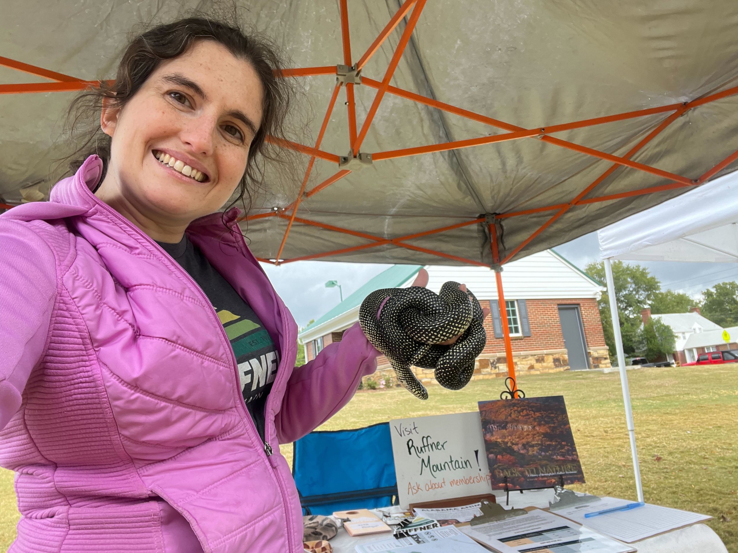    Wildlife Care Naturalist, Emily, holds Ruffie, a speckled kingsnake, Lampropeltis nigra, one of 21 educational animal ambassadors.   