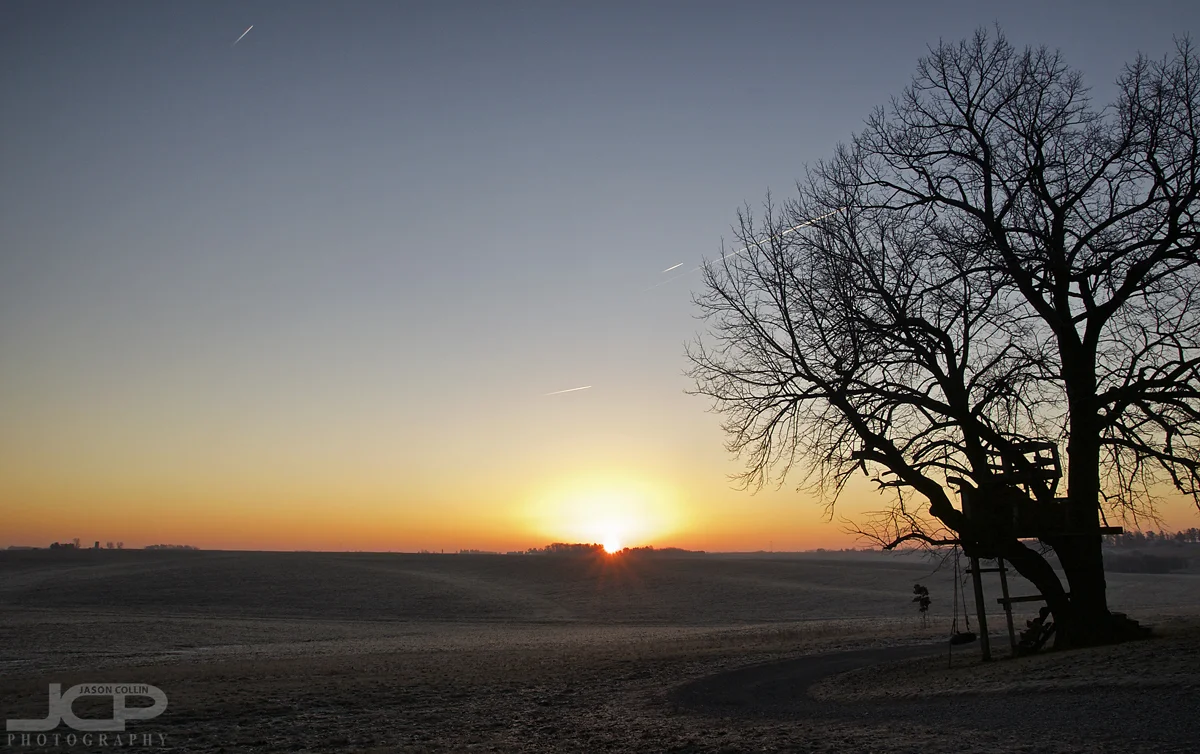 Jets streak through the sky over the first sunrise of 2017 over Iowa farmland - Nikon D300 Tamron 17-50mm tripod mounted with cable release @ f/11 ISO 200 1/50th