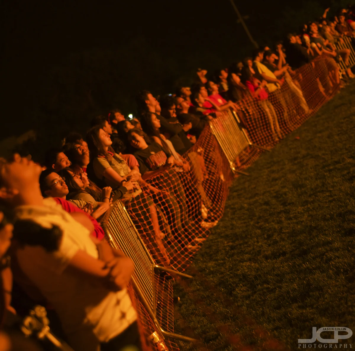 UNM students look on illuminated by fire at the Red Rally 2017 - Nikon D750 with Nikkor 50mm @ f/2 1/60th ISO 1250