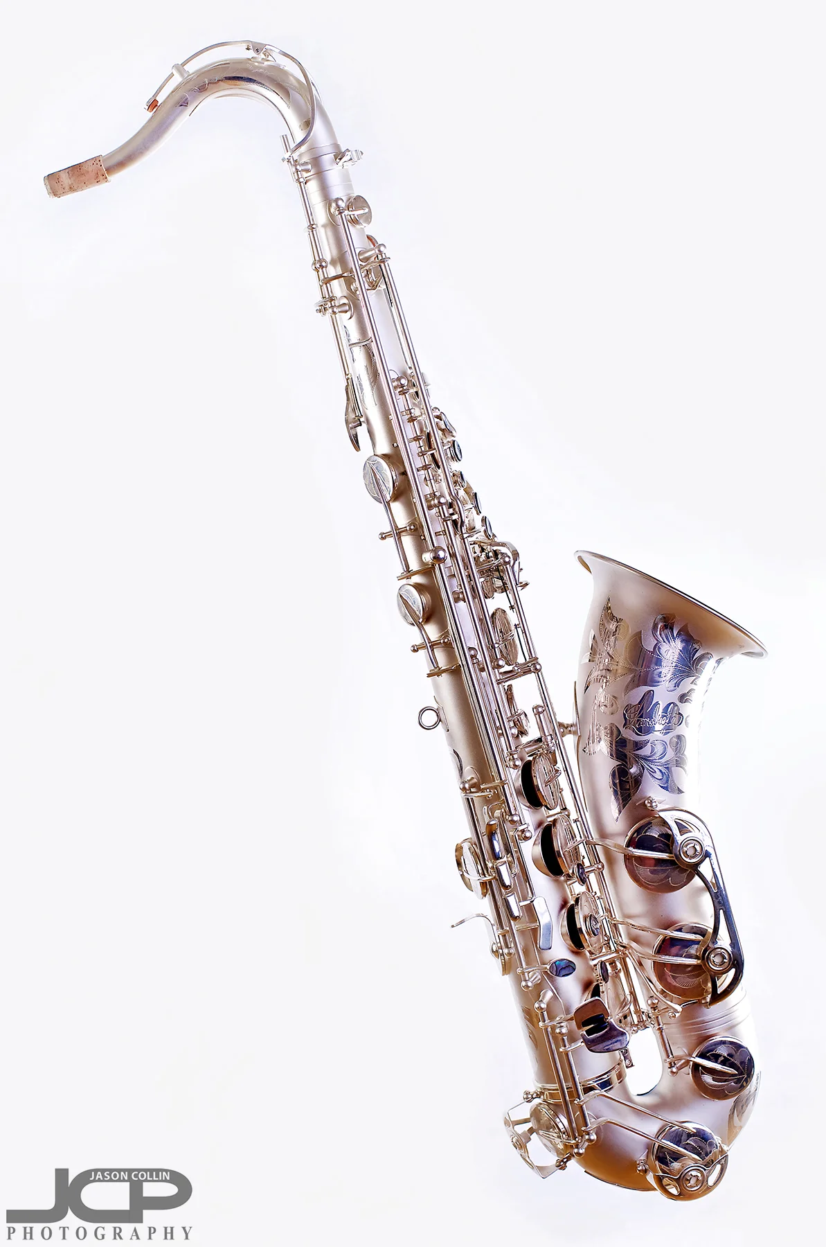 Profile view of this saxophone with stand digitally removed - Nikon D750 with Nikkor 50mm f/1.8G lens @ f/8 1/160th ISO 100 - Strobist: Westcott Strobe Light Plus in 55" octagon gridded soft box main with two 43" shoot through umbrellas with speedlights on the white muslin background