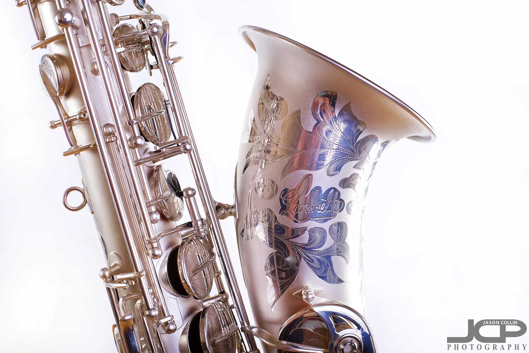 Very detailed etching on this saxophone I photographed in Albuquerque - Nikon D750 with Nikkor 50mm f/1.8G lens @ f/8 1/160th ISO 100 - Strobist: Westcott Strobe Light Plus in 55" octagon gridded soft box main with two 43" shoot through umbrellas with speedlights on the white muslin background
