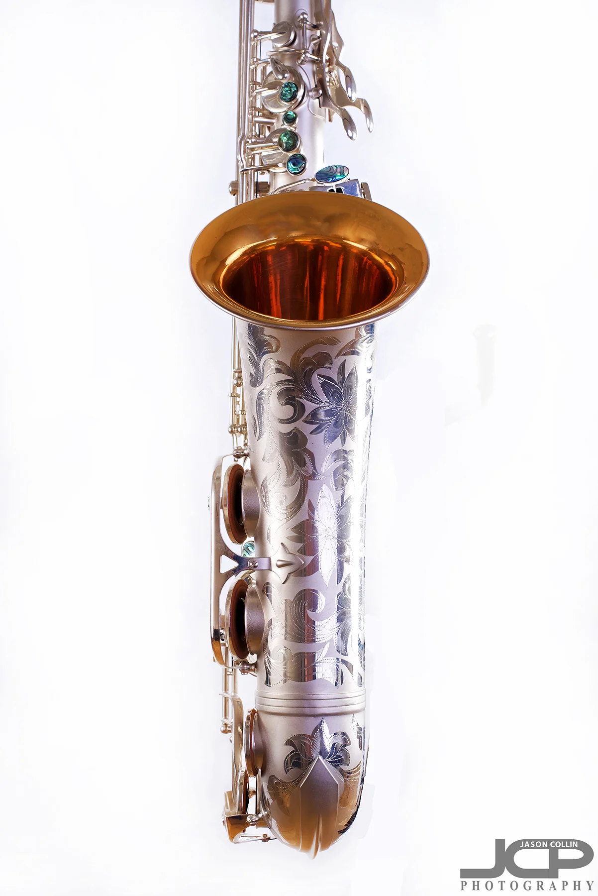 Keeping reflections out of the open part of a saxophone is a challenge - Nikon D750 with Nikkor 50mm f/1.8G lens @ f/11 1/160th ISO 100 - Strobist: Westcott Strobe Light Plus in 55" octagon gridded soft box main with two 43" shoot through umbrellas with speedlights on the white muslin background
