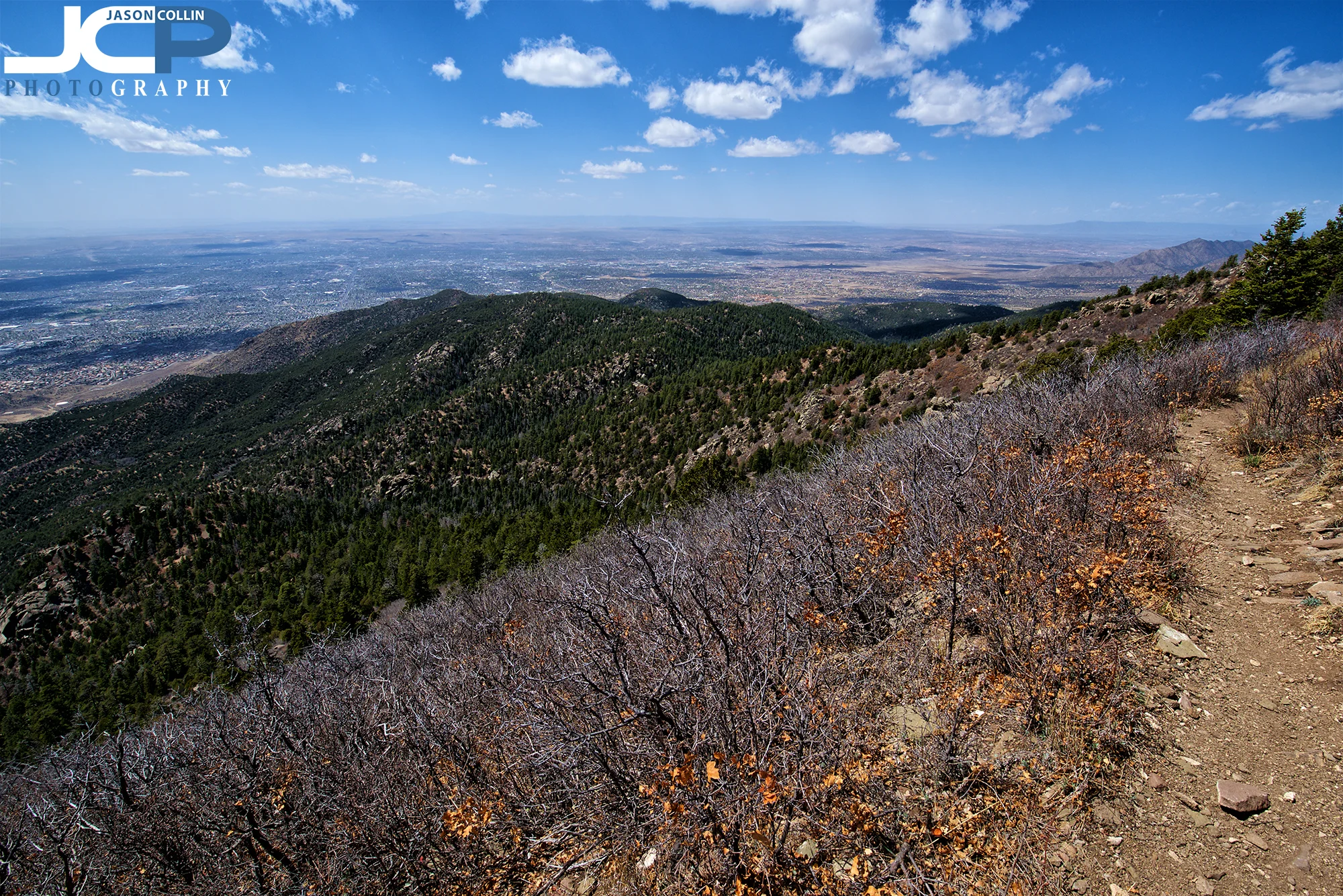 The narrow trail on the final stretch to the South Sandia Peak summit with Albuquerque, New Mexico far below.