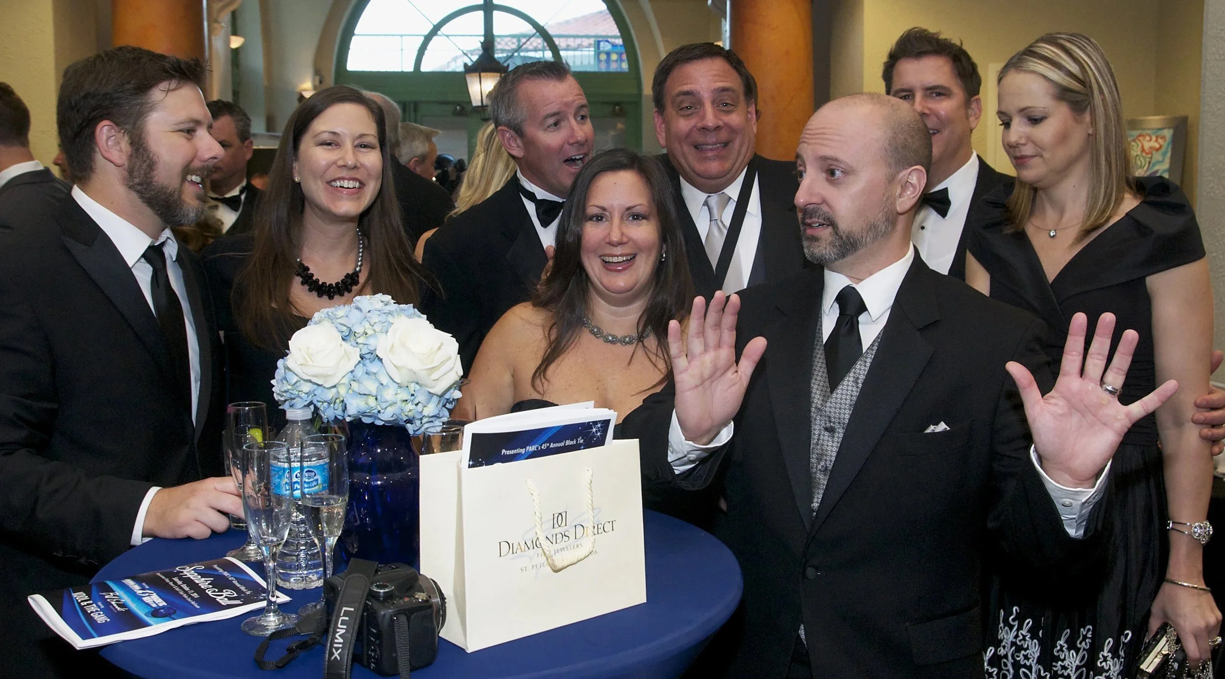 Attendees interacting and smiling during a corporate networking event