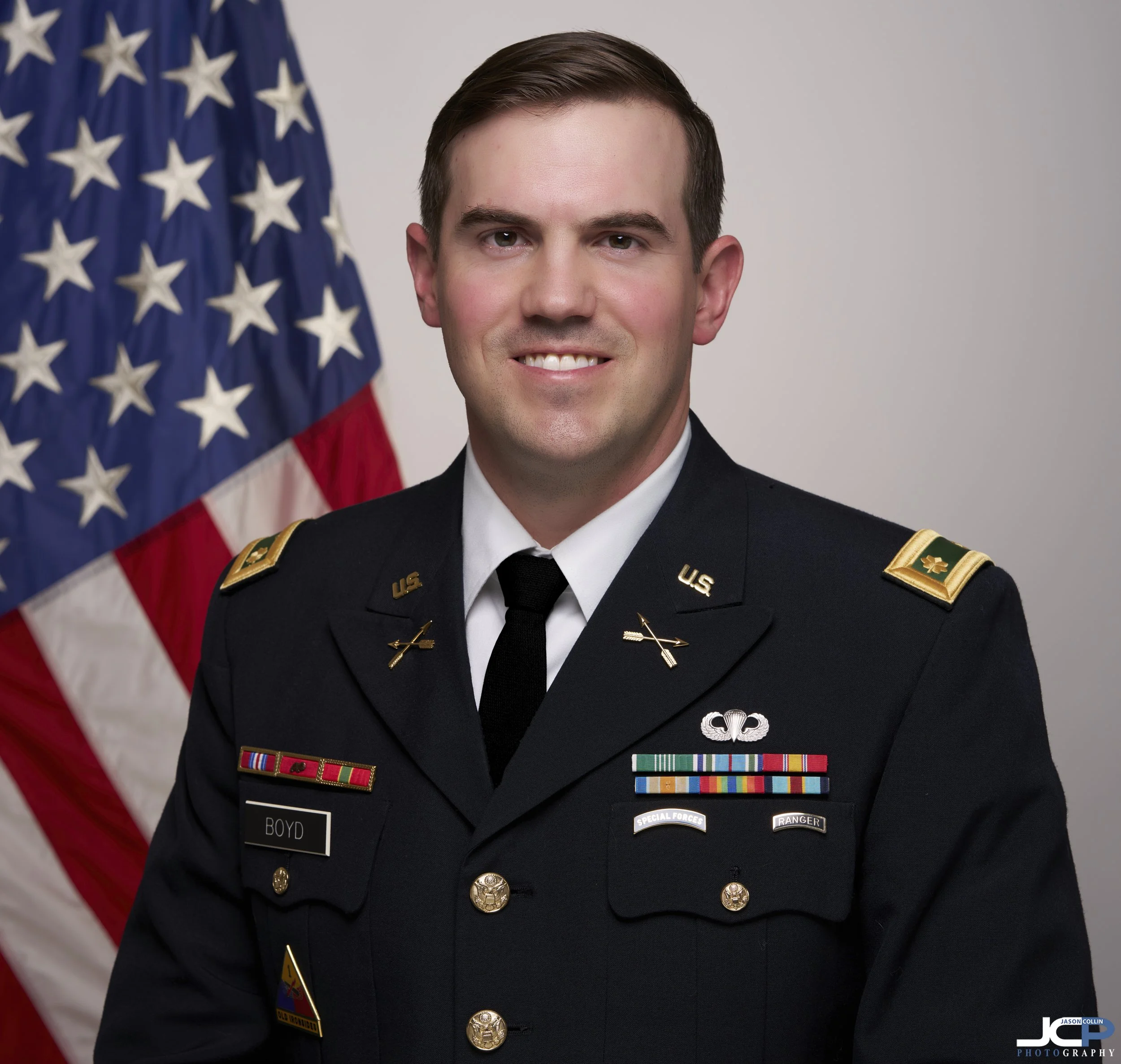 Professional military headshot with American flag backdrop in studio lighting, Pacific Grove California