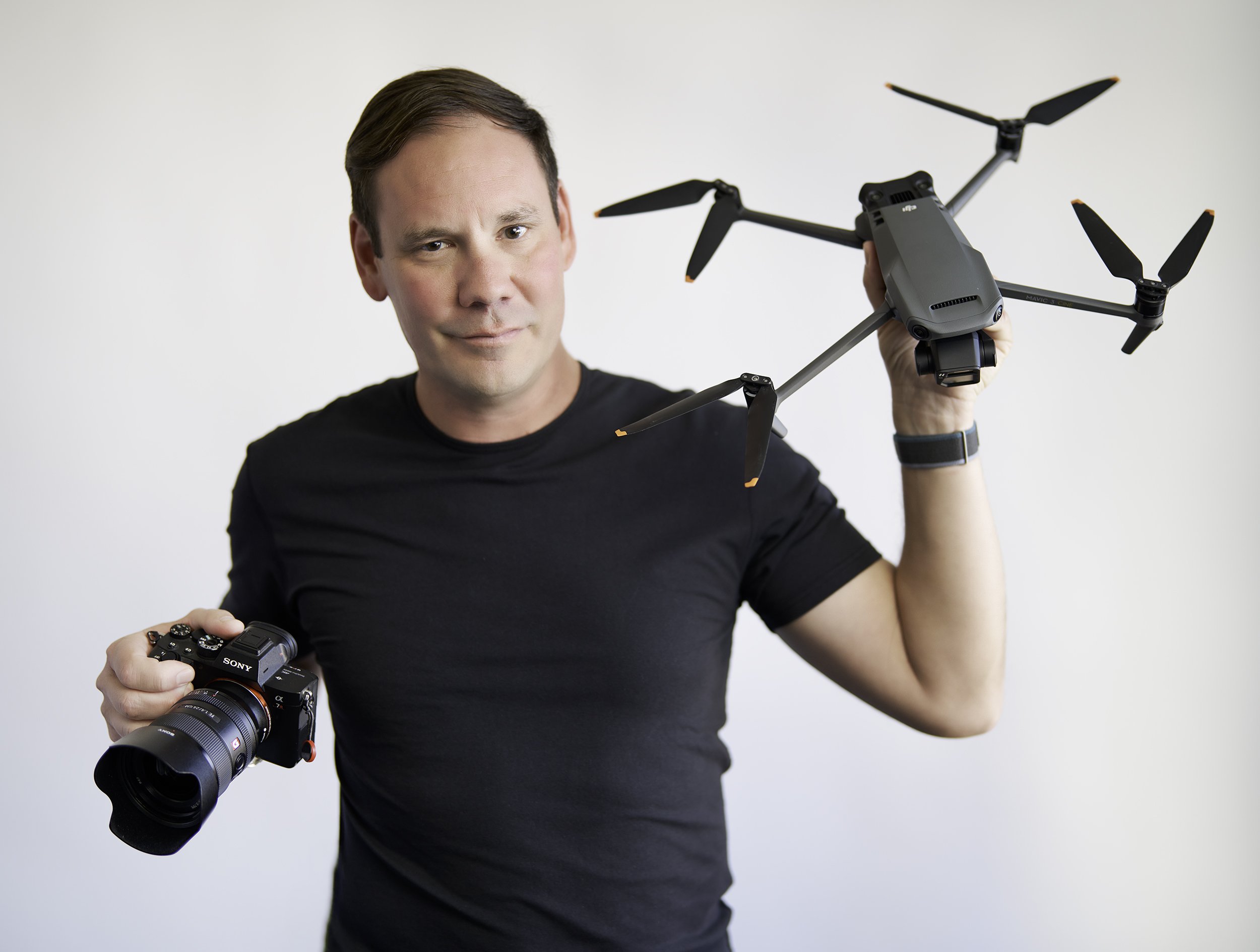 Local Pacific Grove Photographer Jason Collin holding his drone and camera