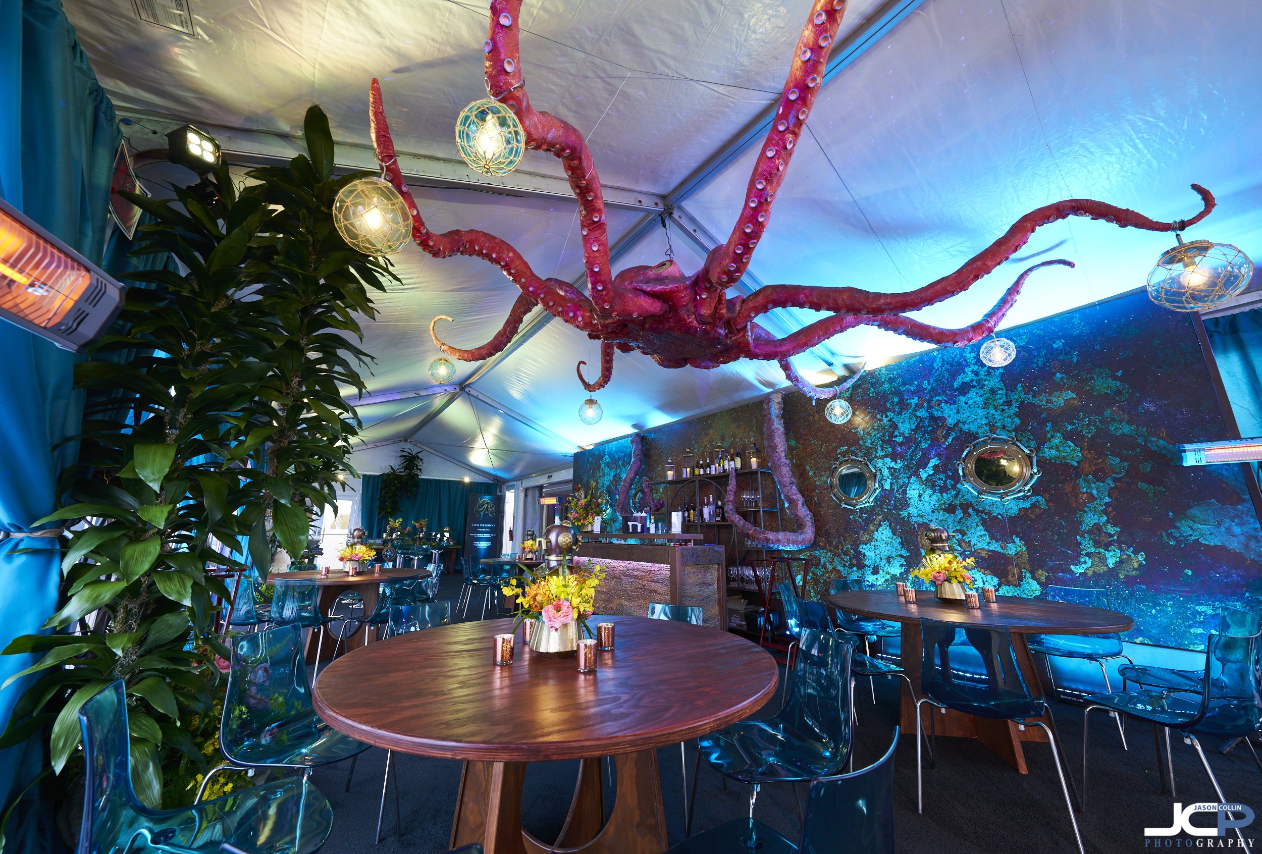 Sea-themed luxury event setup at Monterey Plaza Hotel during AT&T Pro-Am week, featuring dramatic octopus ceiling installation and custom décor by Illusions of Grandeur.