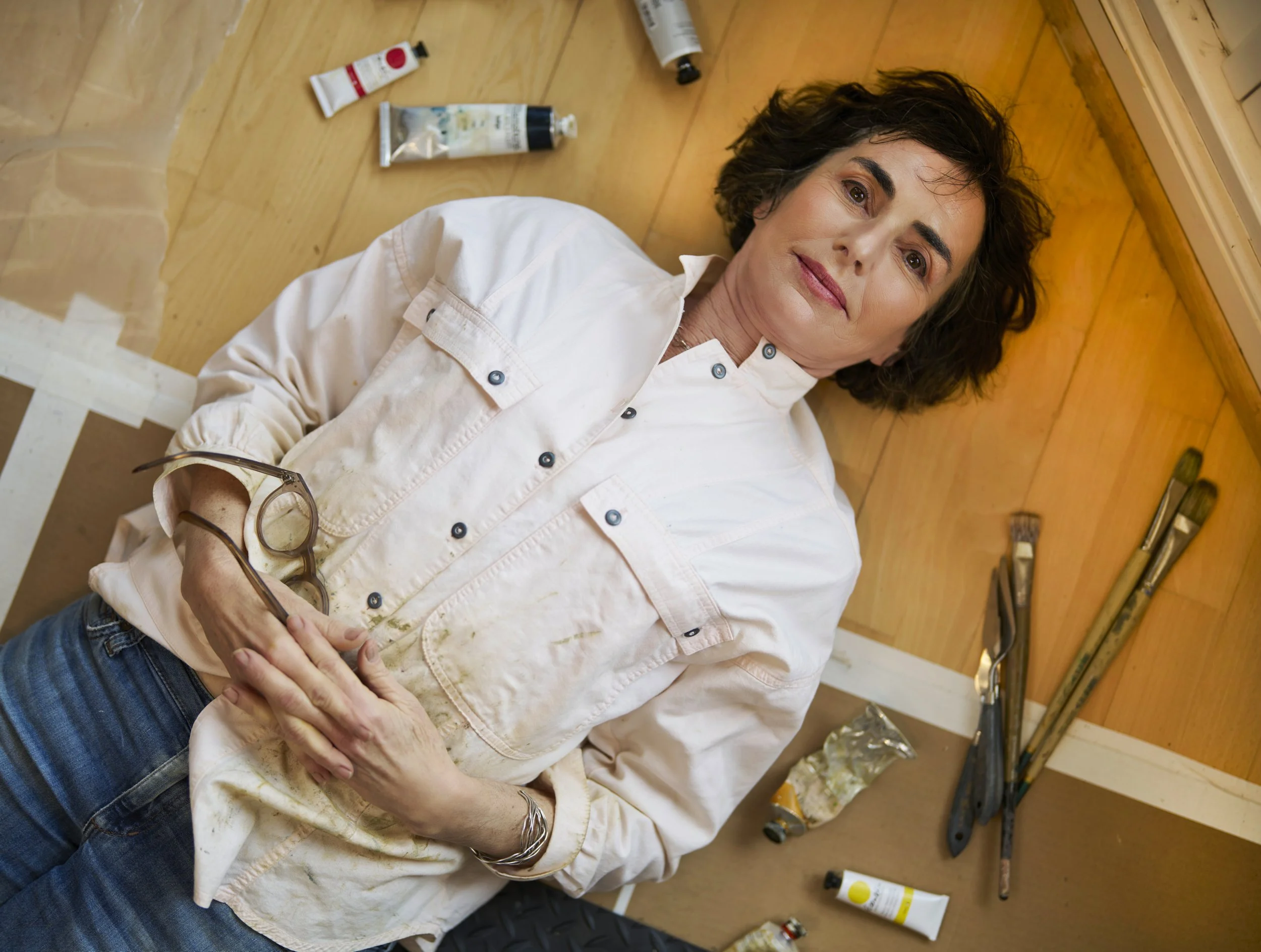 painter lying on floor for a personal branding photo Pacific Grove