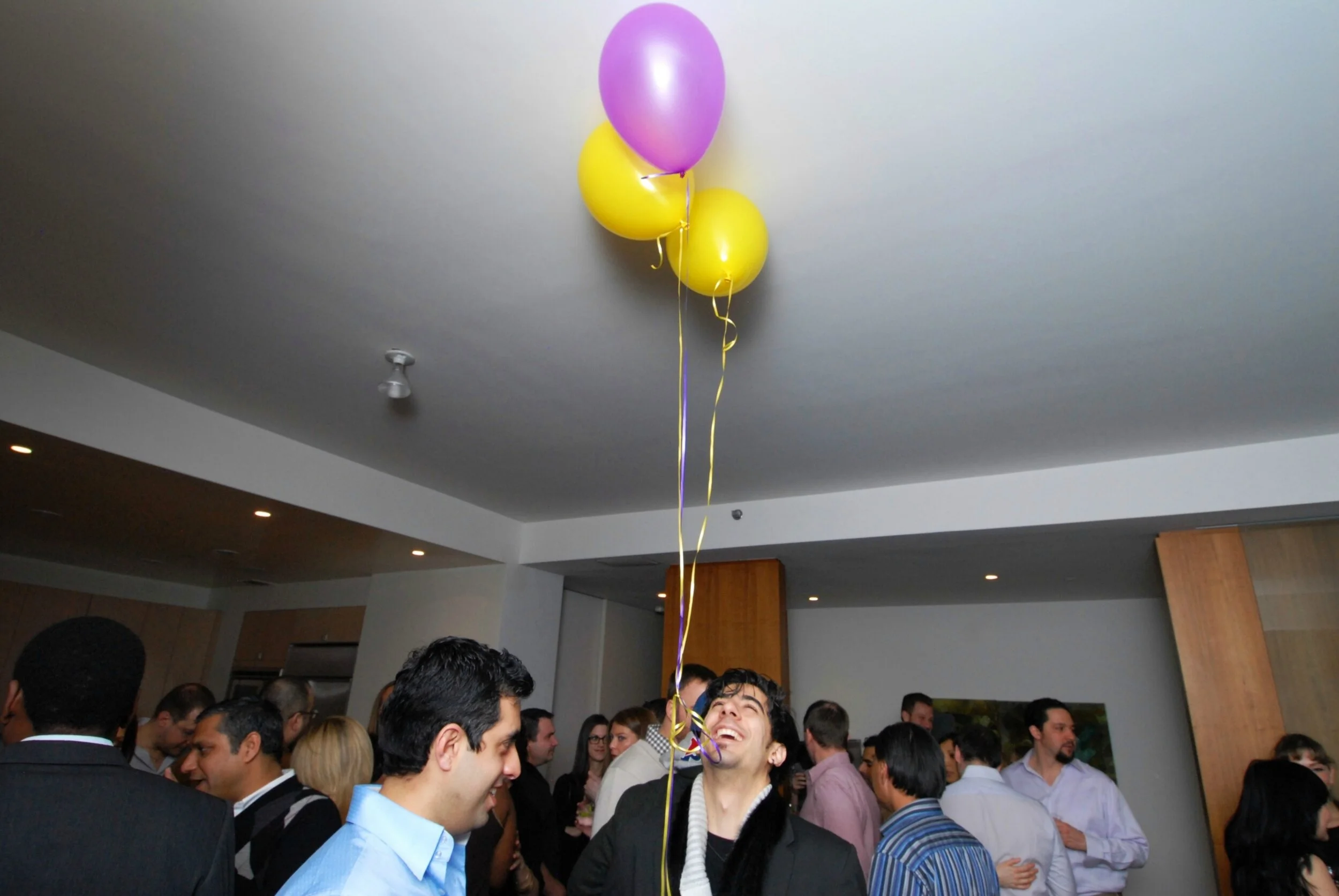 corporate-photograher-christopher-wells-guys-looking-at-balloon-birthday.jpg