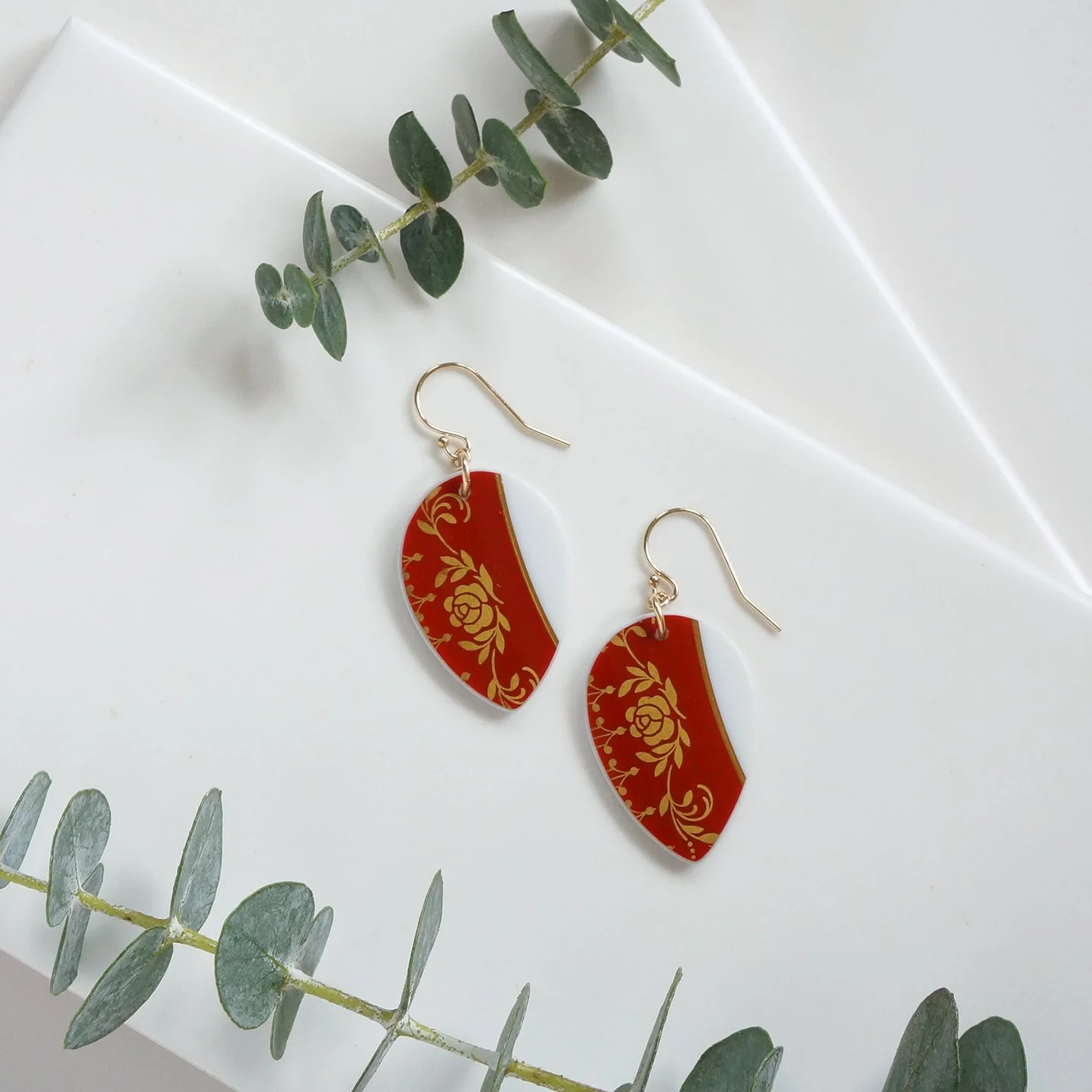 Vintage China made into drop shaped dangle earrings that are red and gold. With gold fill ear wires.