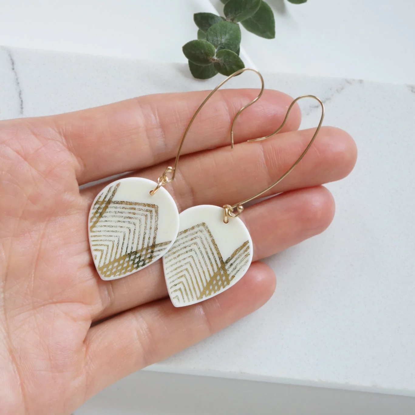 Drop shaped Earrings made from vintage bavarian china with geometric gold lines, and gold fill extra long ear wires by material and movement