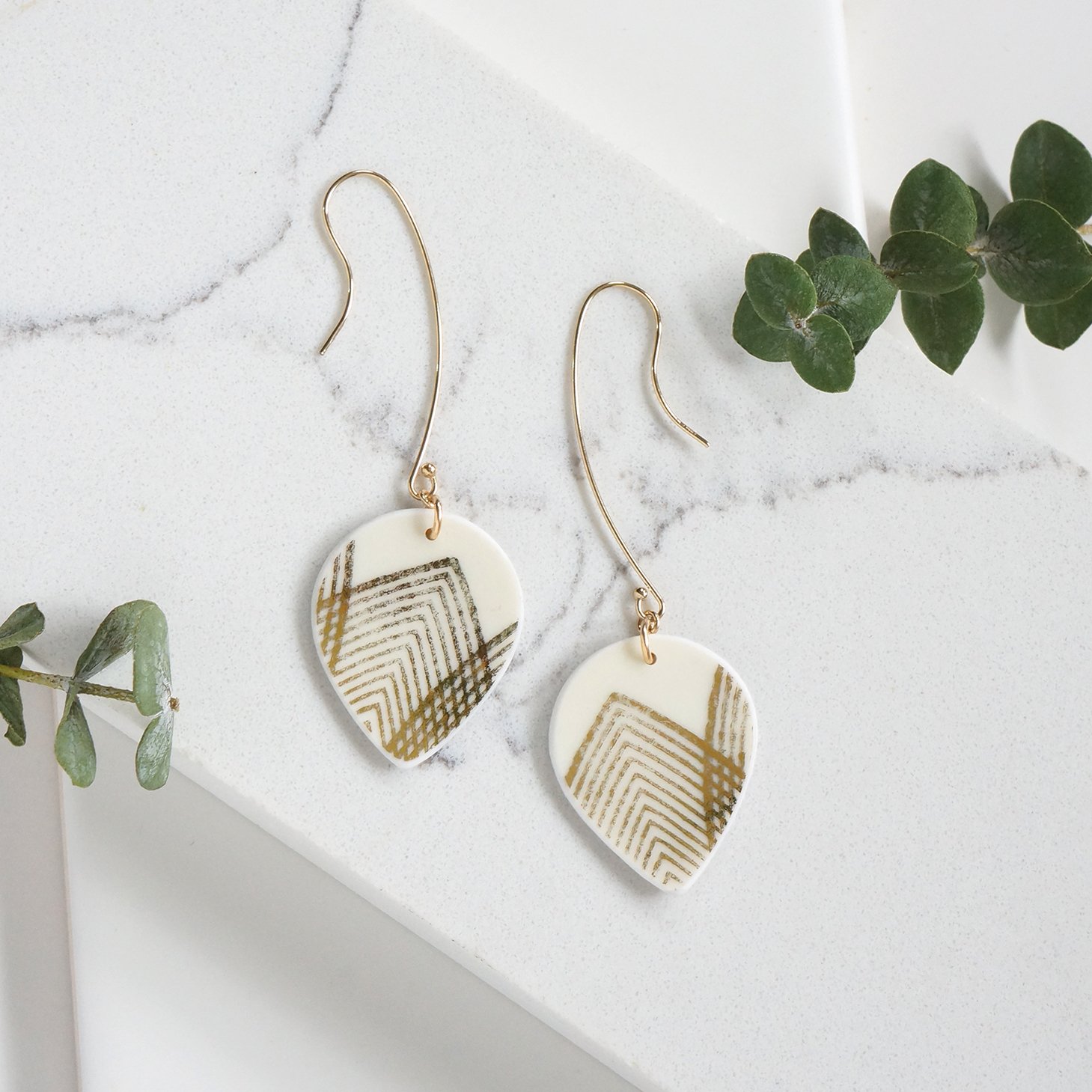 Drop shaped Earrings made from vintage bavarian china with geometric gold lines, and gold fill extra long ear wires by material and movement