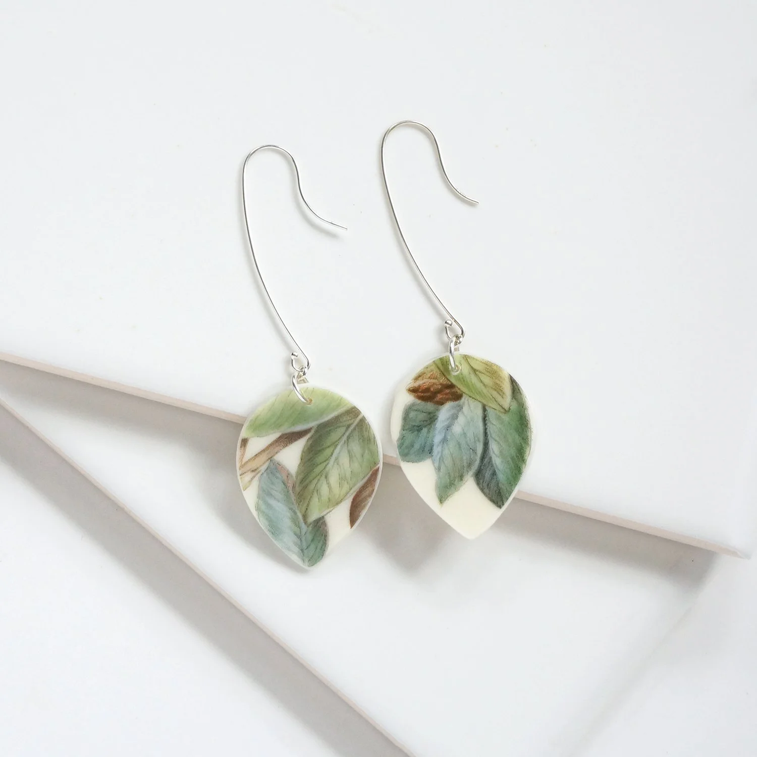 drop shaped Earrings made from vintage boehm illustration china with green leaves and sterling silver extra long ear wires by material and movement