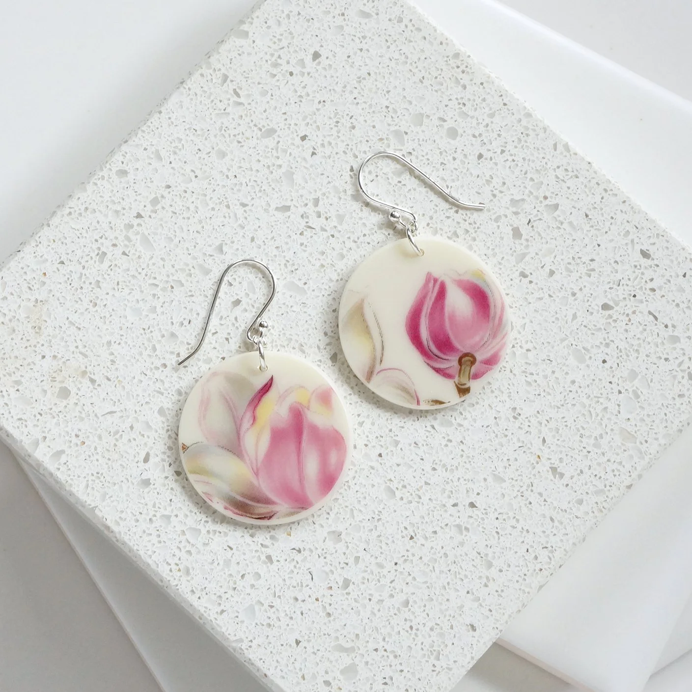 Round orb shaped Earrings made from vintage Boehm illustration china with pastel pink and grey tulips and sterling silver ear wires by material and movement