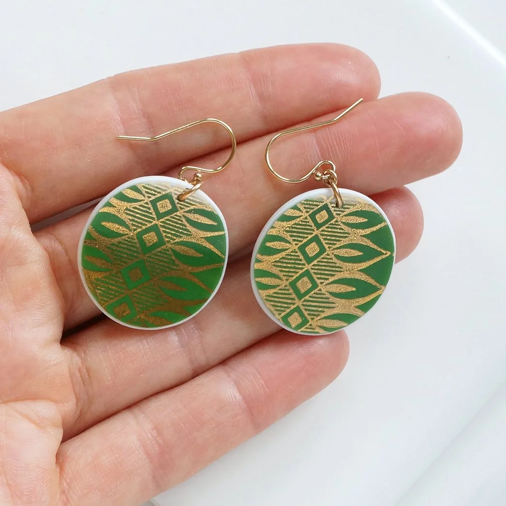 Round orb shaped Earrings made from vintage Bavarian china with green and shiny gold and gold fill ear wires by material and movement