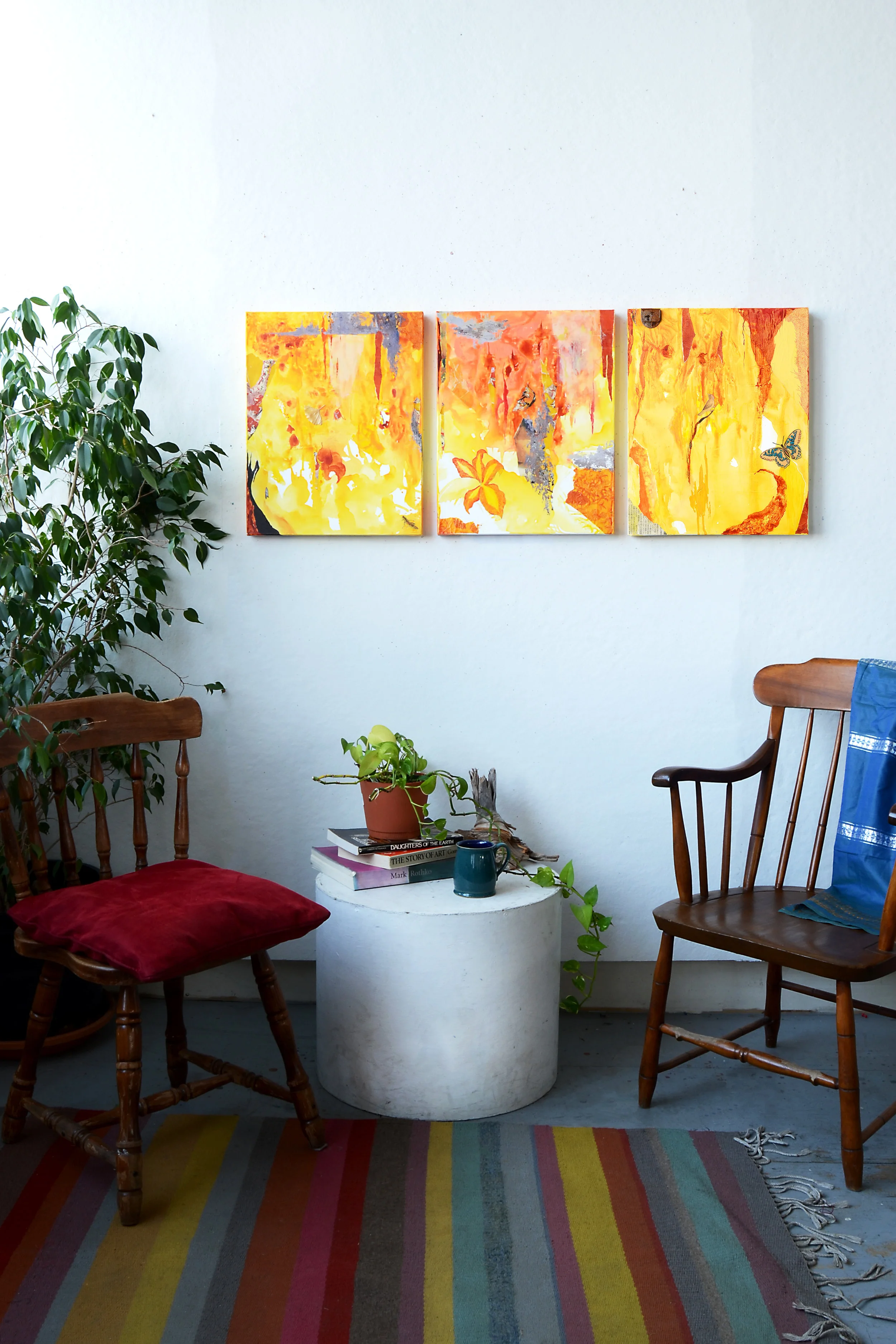 Three yellow paintings on wall