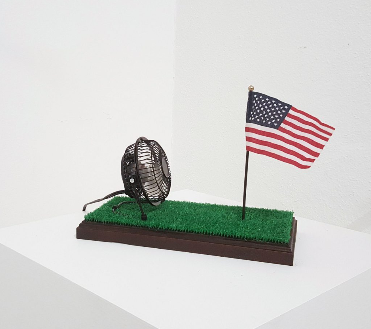 2018, Patriot Kit Miniature Oak stained pedestal modeled after the Presidential Resolute Desk affixed with artificial lawn, chinese made nail salon fan, and mini flag.