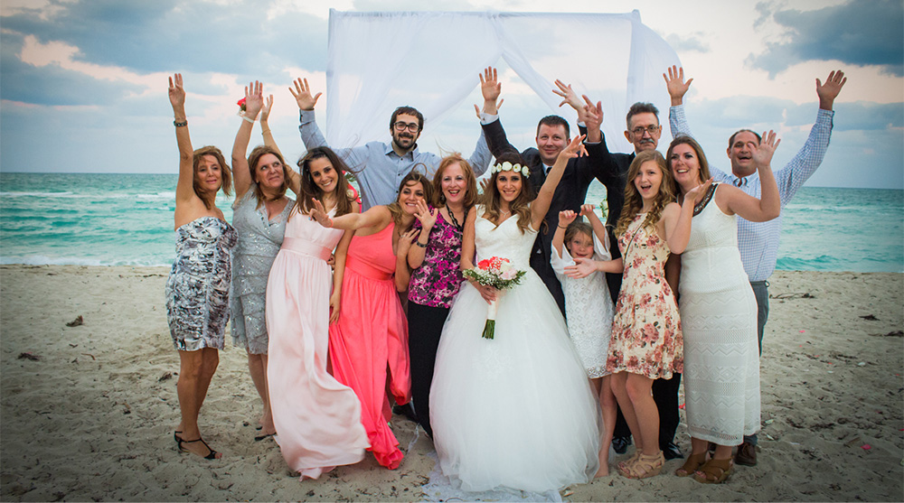 family-wedding-portraits-beach-ceremony-biracial-fun-smiling-goofy-oceanview-arch-pink-bridesmaid-gowns-wedding-dress-los-angeles-wedding-photographer-southern-california-engagement.jpg