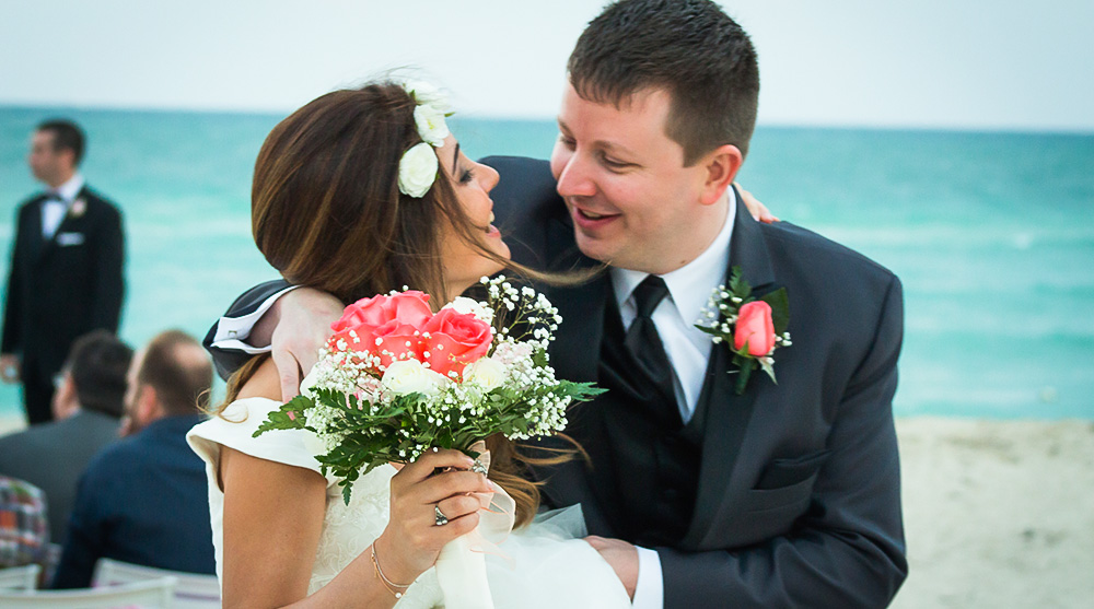 smiling-bride-groom-miami-beach-wedding-ceremony-bouquet-floral-headband-laughing-los-angeles-elopement-engagement-photographer-happy-ocean.jpg