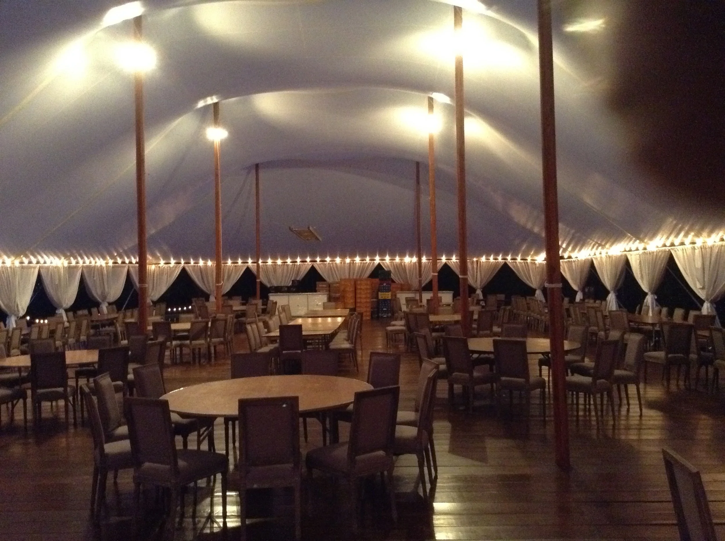 Sailcloth tent 59' x 99' with hardwood floor and carriage lighting