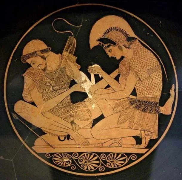 Achilles tending Patroclus wounded by an arrow, identified by inscriptions on the upper part of the vase. Tondo of an Attic red-figure kylix, circa 500 BC. From Vulci. ( Public Domain )