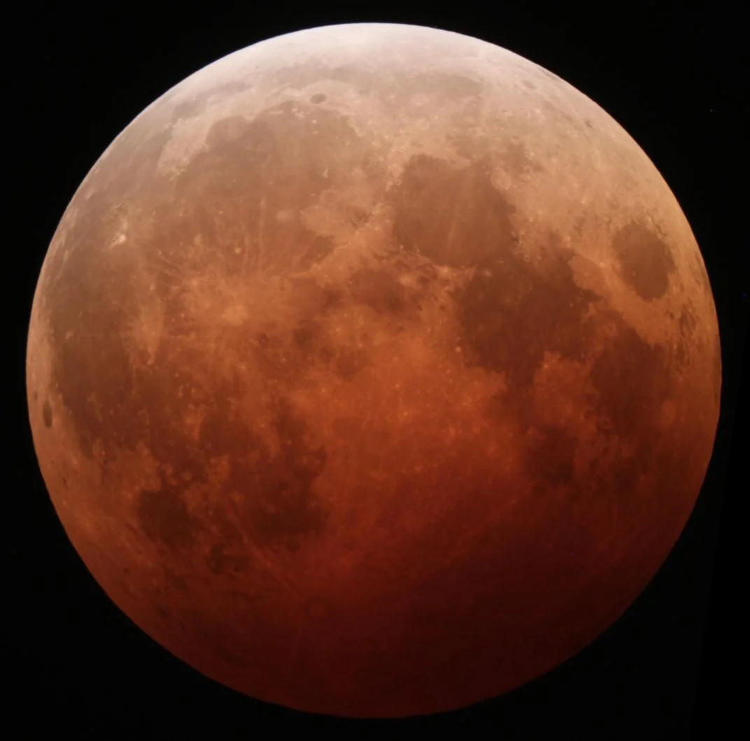 The total lunar eclipse of October 8, 2014, as photographed from California. When the shadow of the Earth covers the moon, only light filtered through Earth's atmosphere reaches the lunar surface, casting the moon in a reddish glow. ( Alfredo Garcia, Jr. / Flickr under CC BY-SA 2.0 )