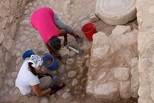 In this photo provided from the Department of Antiquities of Cyprus, on Wednesday, Aug. 14, 2019, Archeologists work at the archeological site area during the 2019 excavation season at Kouklia outside in southwest city of Paphos, Cyprus. Archaeologists say the discovery of a small clay shard inscribed with a partial inventory of goods at a 2,500 year-old citadel suggests that Cyprus' ancient city states "more than likely" had a homegrown, common economic management system. (Department of Antiquities of Cyprus via AP)
