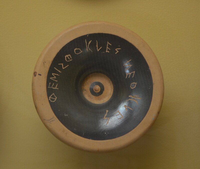   Ostrakon  made from the base of a fine kylix (a wine-drinking cup), with the name Themistokles, son of Neokles. 