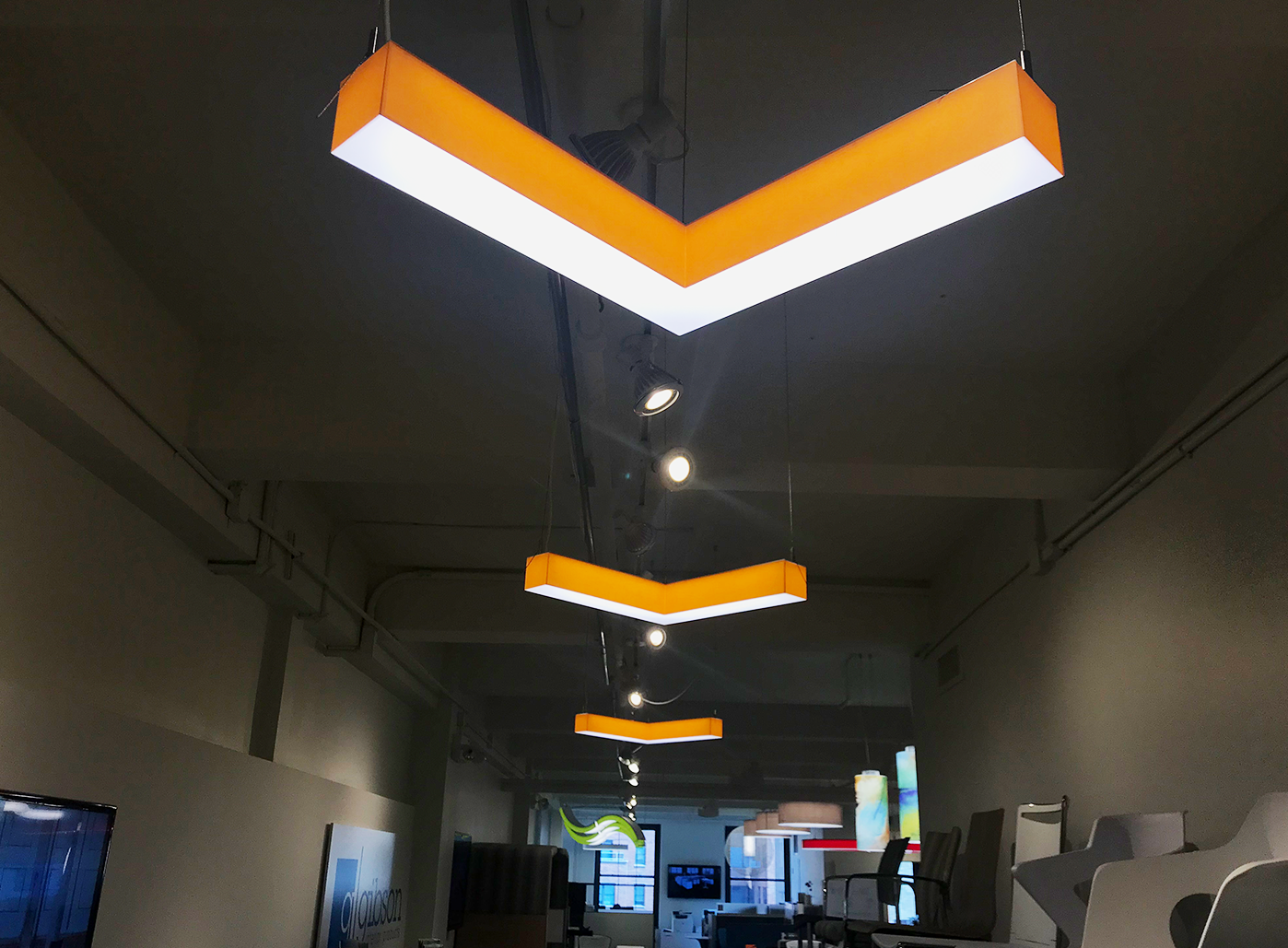 Walking into the showroom, three Veer fixtures are hanging on the ceiling, almost like directionals. The Veer is part of Metro, Barbican's beautiful modular system. These components were used individually but can be combined with other parts of the Metro system to create gorgeous patterns and visuals. Made with specialized laminated shade material, each Metro product is durable and less prone to damage during installation and day-to-day interactions than traditional fabric shades. The most amazing thing about the Metro system is that any color can be used to match any setting and environment.